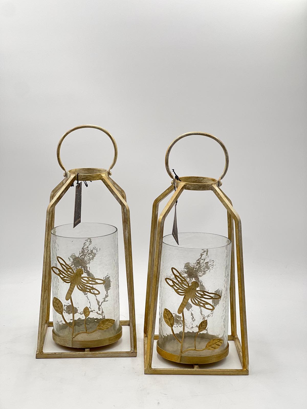 Two gold lanterns with glass cylinders and dragonfly accents