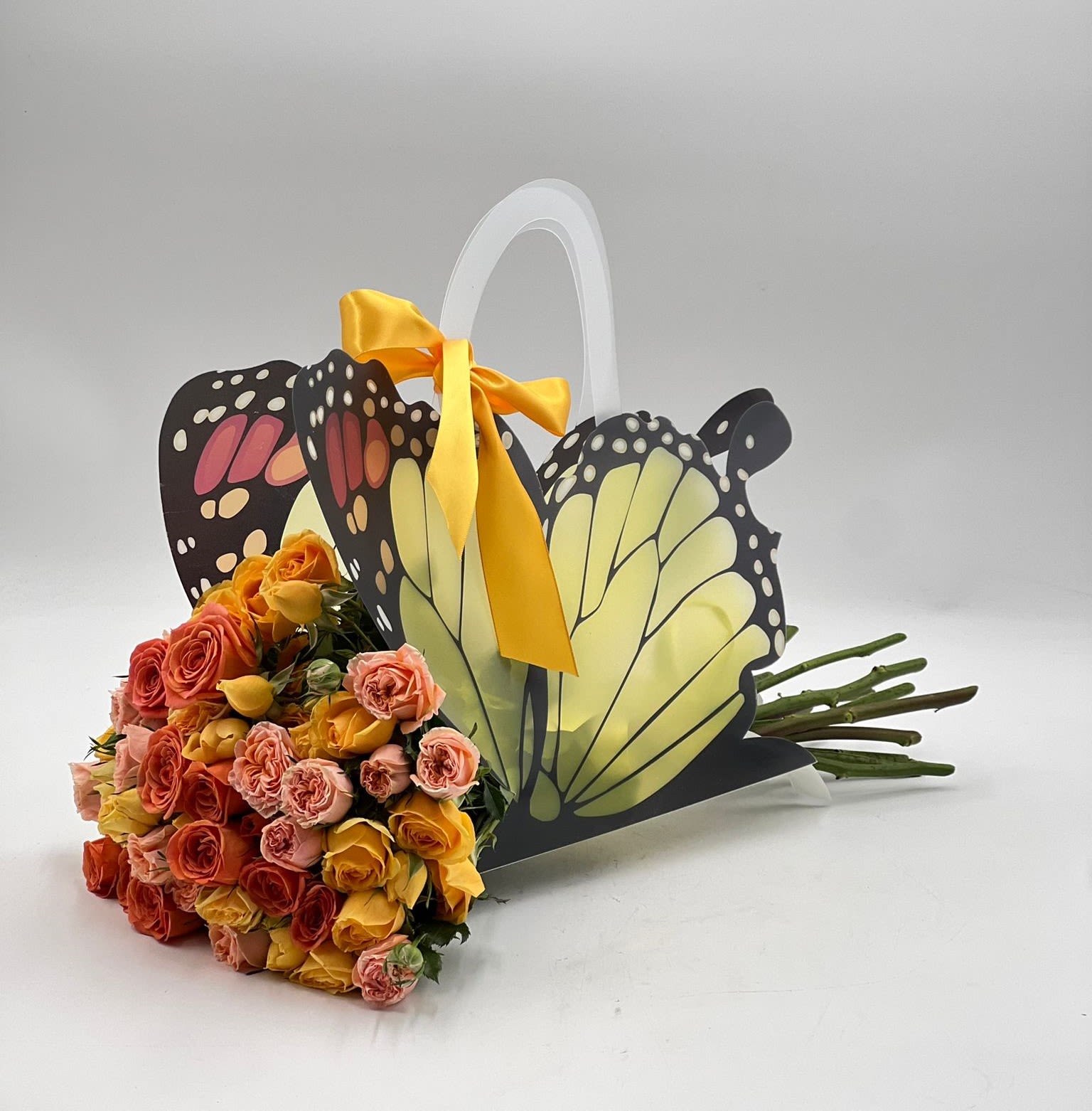 Bouquet of multicolored roses in a butterfly-shaped gift basket
