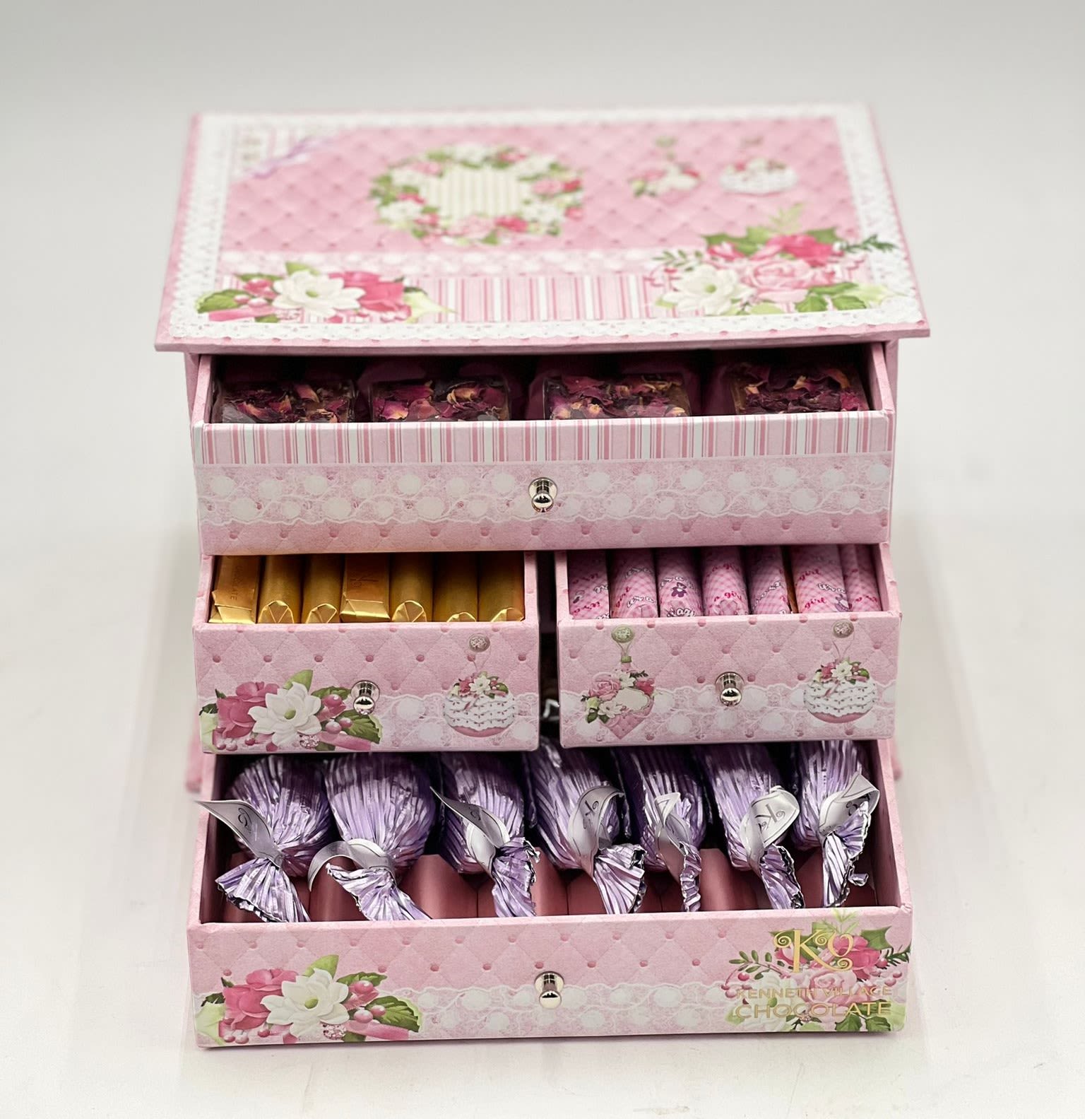 Pink floral gift box with drawers of wrapped chocolates