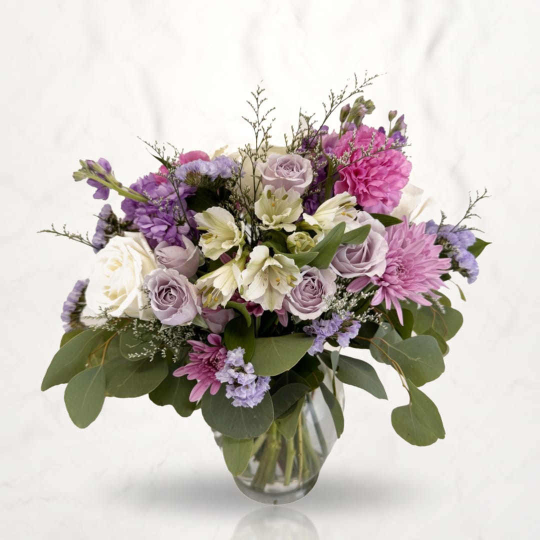 Lavender and pink mixed bouquet in a clear glass vase
