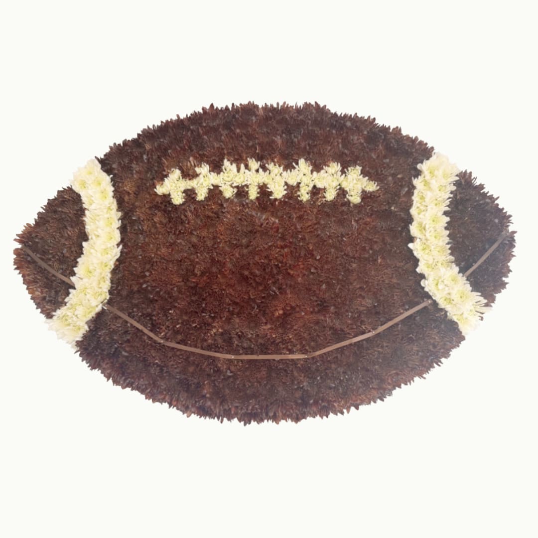 Football-shaped floral arrangement with white flower accents