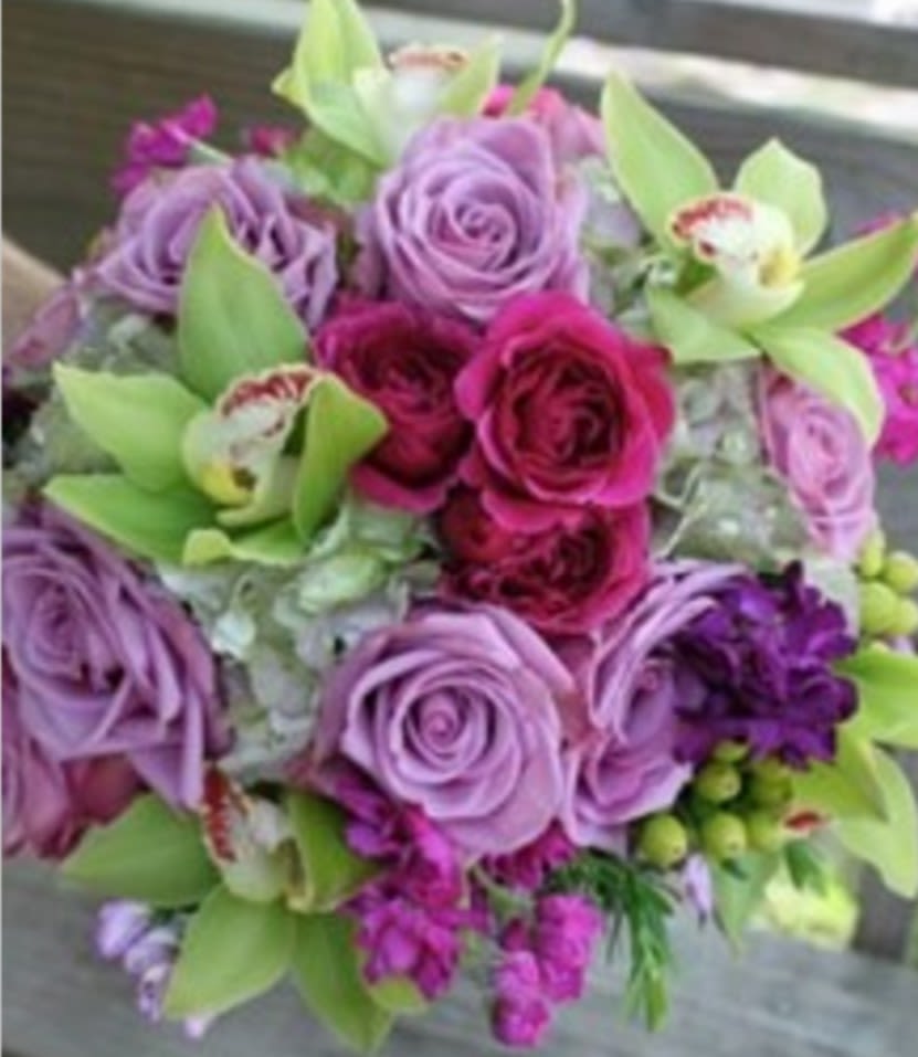 Bouquet of purple and pink roses with green orchids