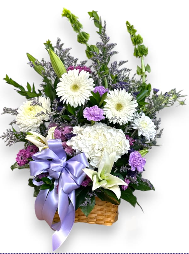 Basket arrangement of white and purple flowers with a lavender ribbon