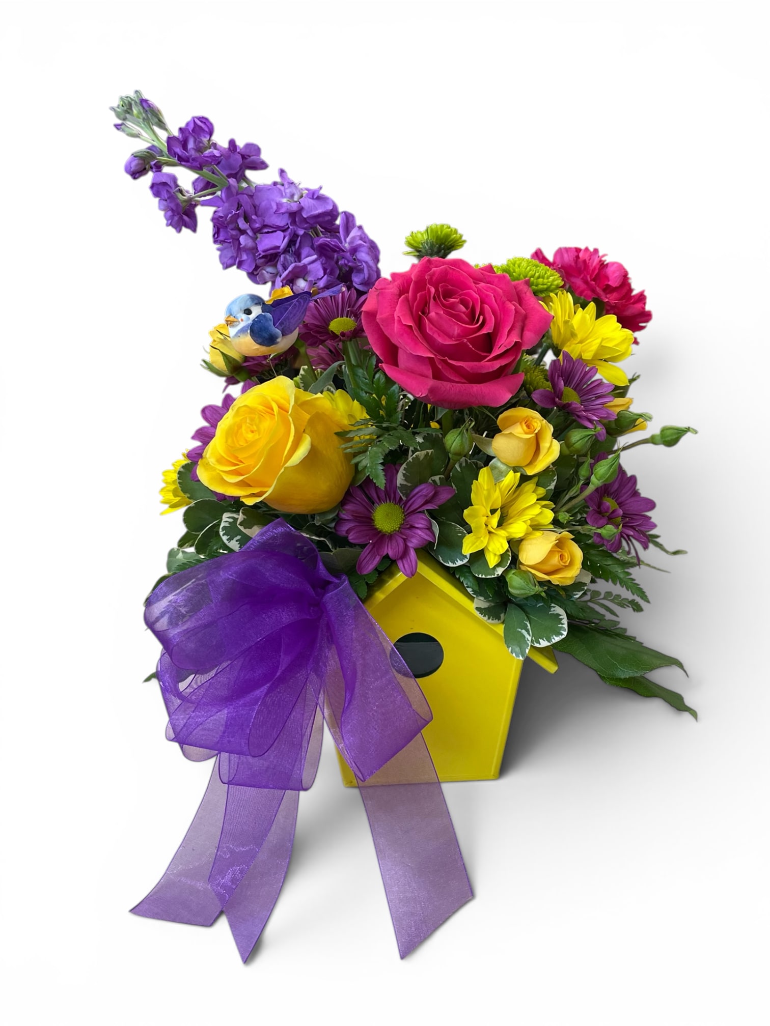 Birdhouse Blossoms  - Delight in the charm of the outdoors with our Birdhouse Blossoms arrangement.  Fresh, vibrant flowers are artfully arranged in a whimsical birdhouse container, accented by a sweet little bird perched atop. This unique centerpiece brings a touch of garden magic indoors—perfect for brightening any space or gifting to someone special who loves nature’s beauty.