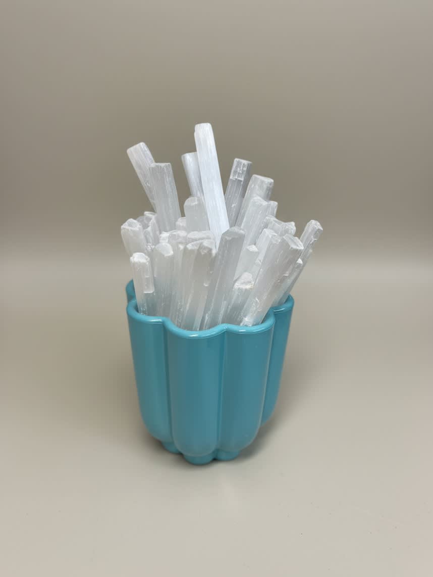 Blue cup holding white crystal-like sticks
