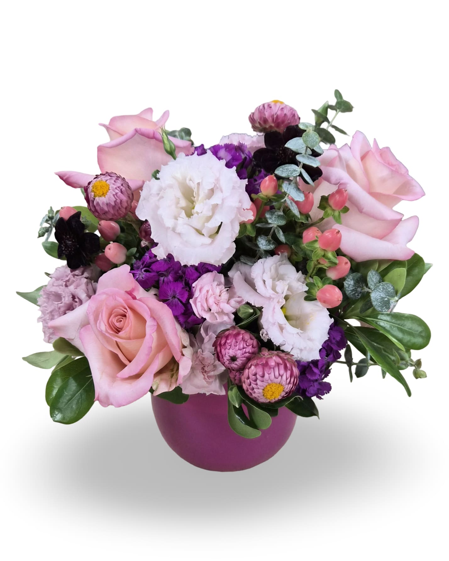 Pink roses and white blooms arranged in a purple vase