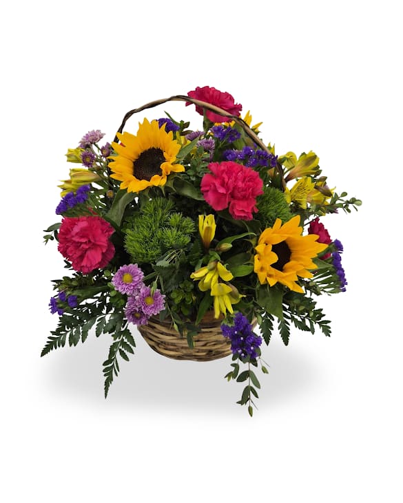 Basket arrangement with sunflowers, pink carnations, and purple flowers