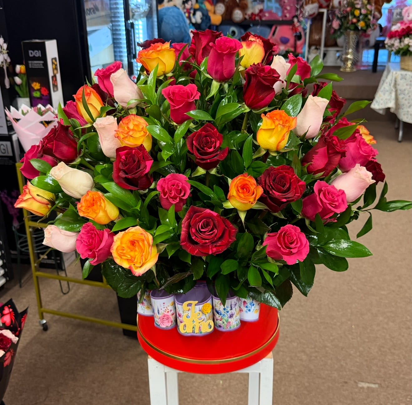 Large bouquet of multicolored roses in a decorative container