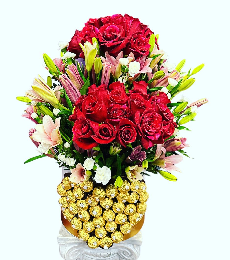 Red rose bouquet with pink lilies and Ferrero Rocher chocolates in a decorative container