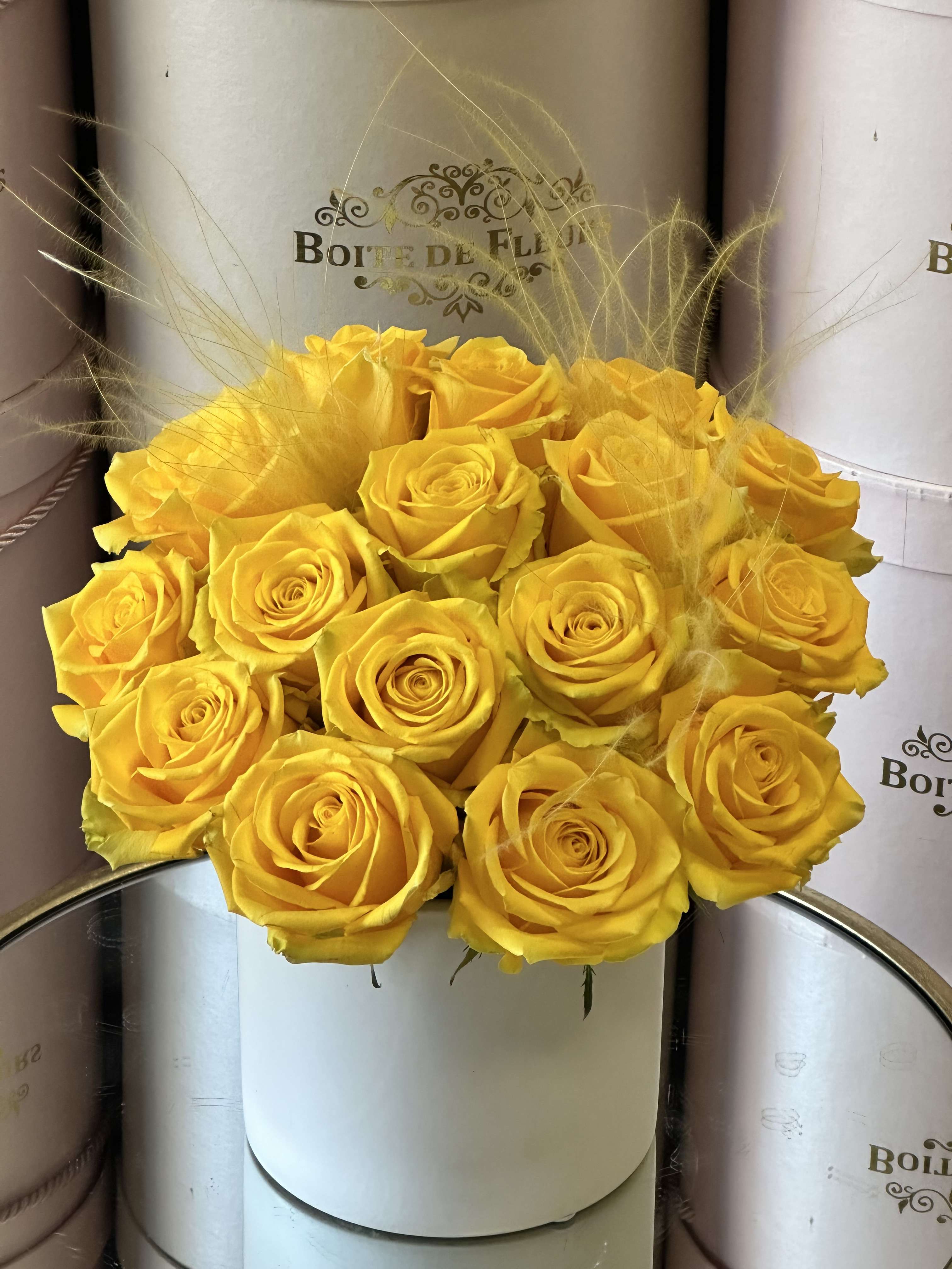Yellow rose bouquet in a white round box