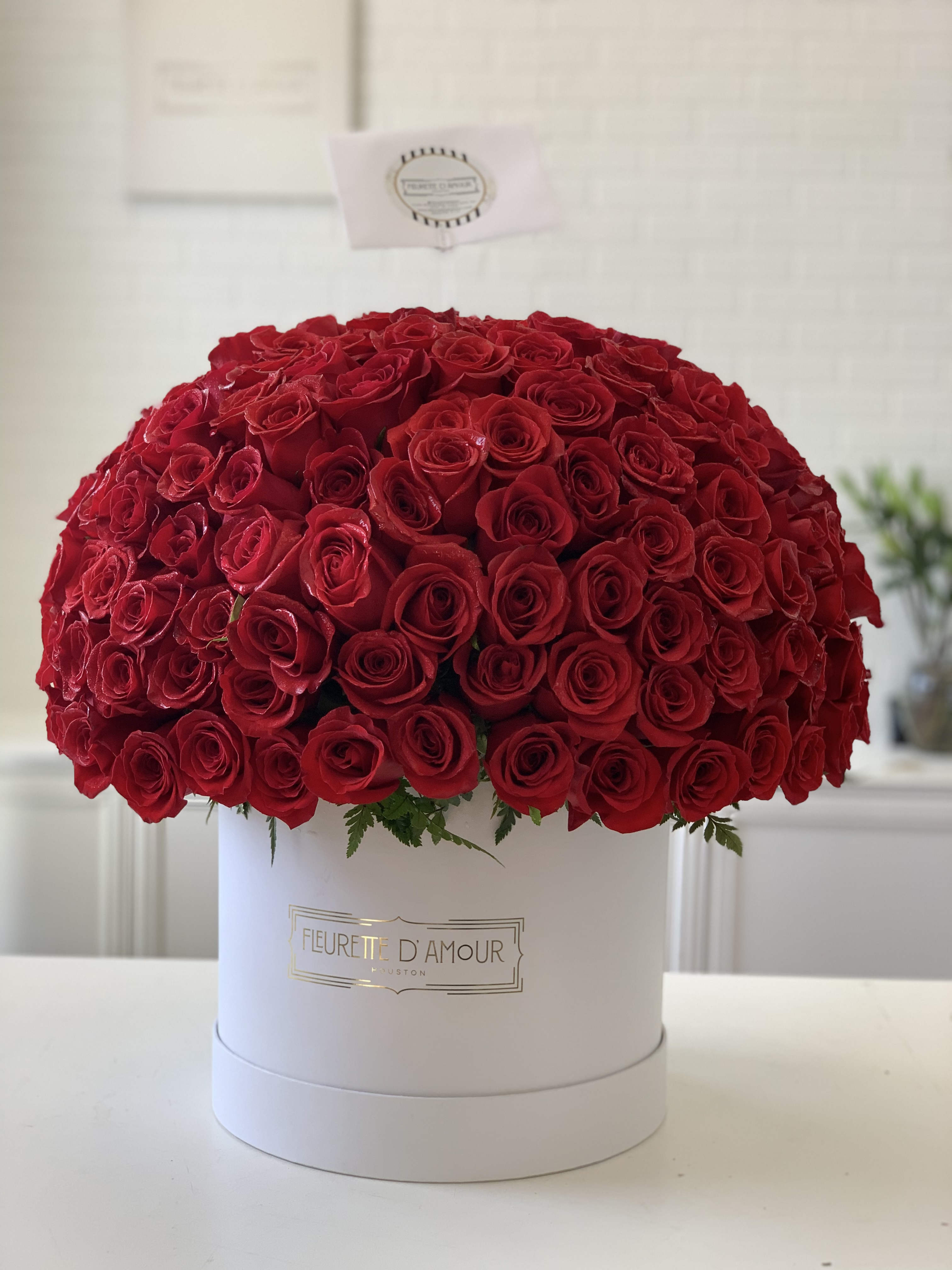 Large dome of red roses in a white hat box