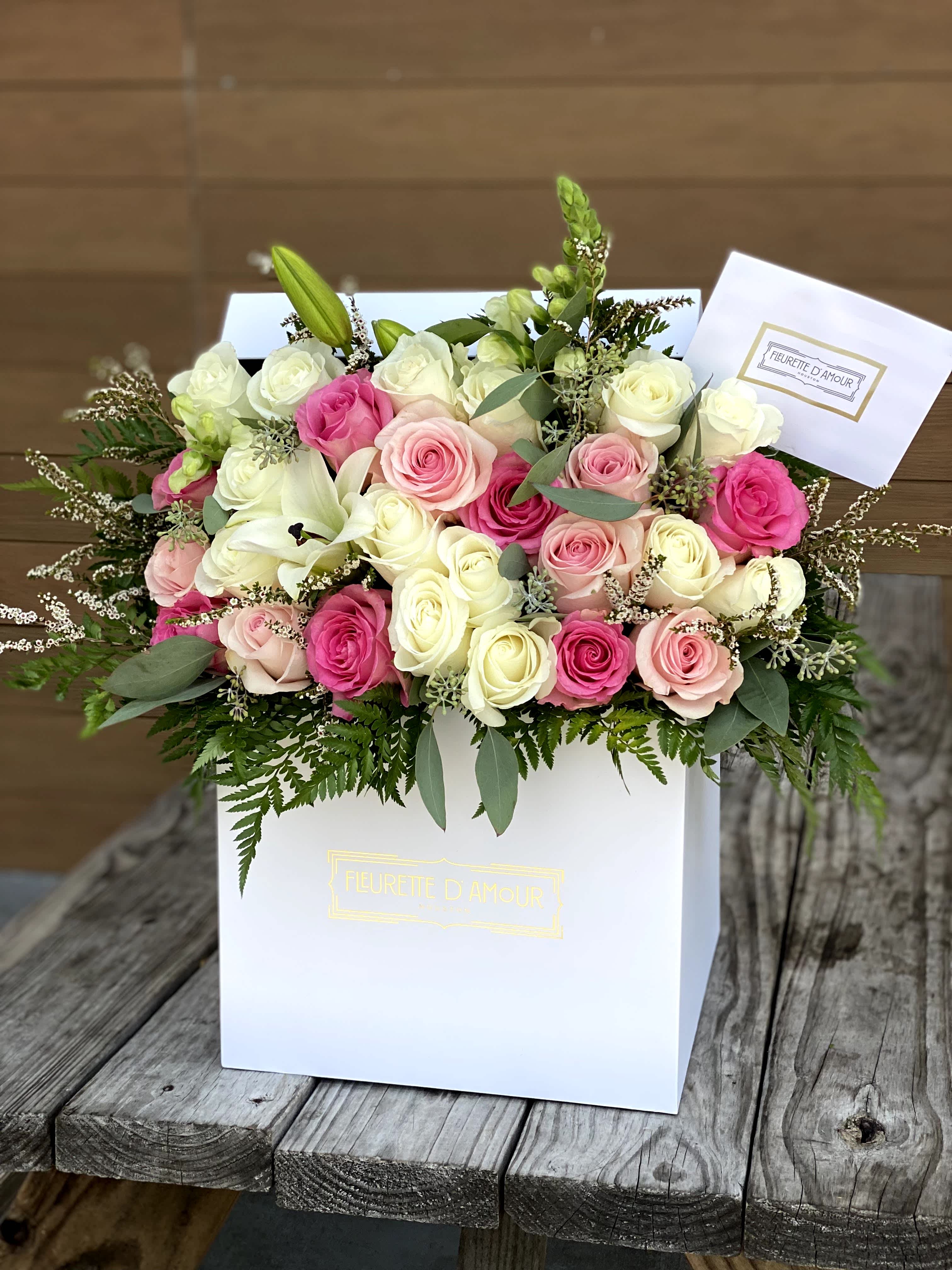 Pink and white rose bouquet in a white gift box