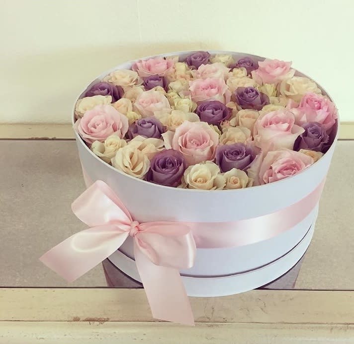 Colors of Spring Roses - Round white base filled with purple, pink, and white roses.