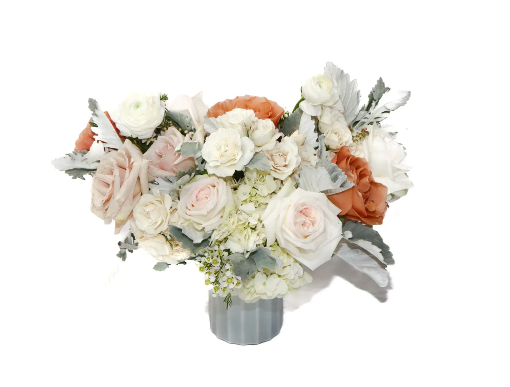 White and blush rose bouquet in a gray vase
