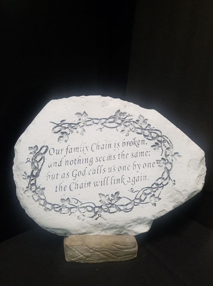 Decorative stone plaque with a memorial quote and floral vine border