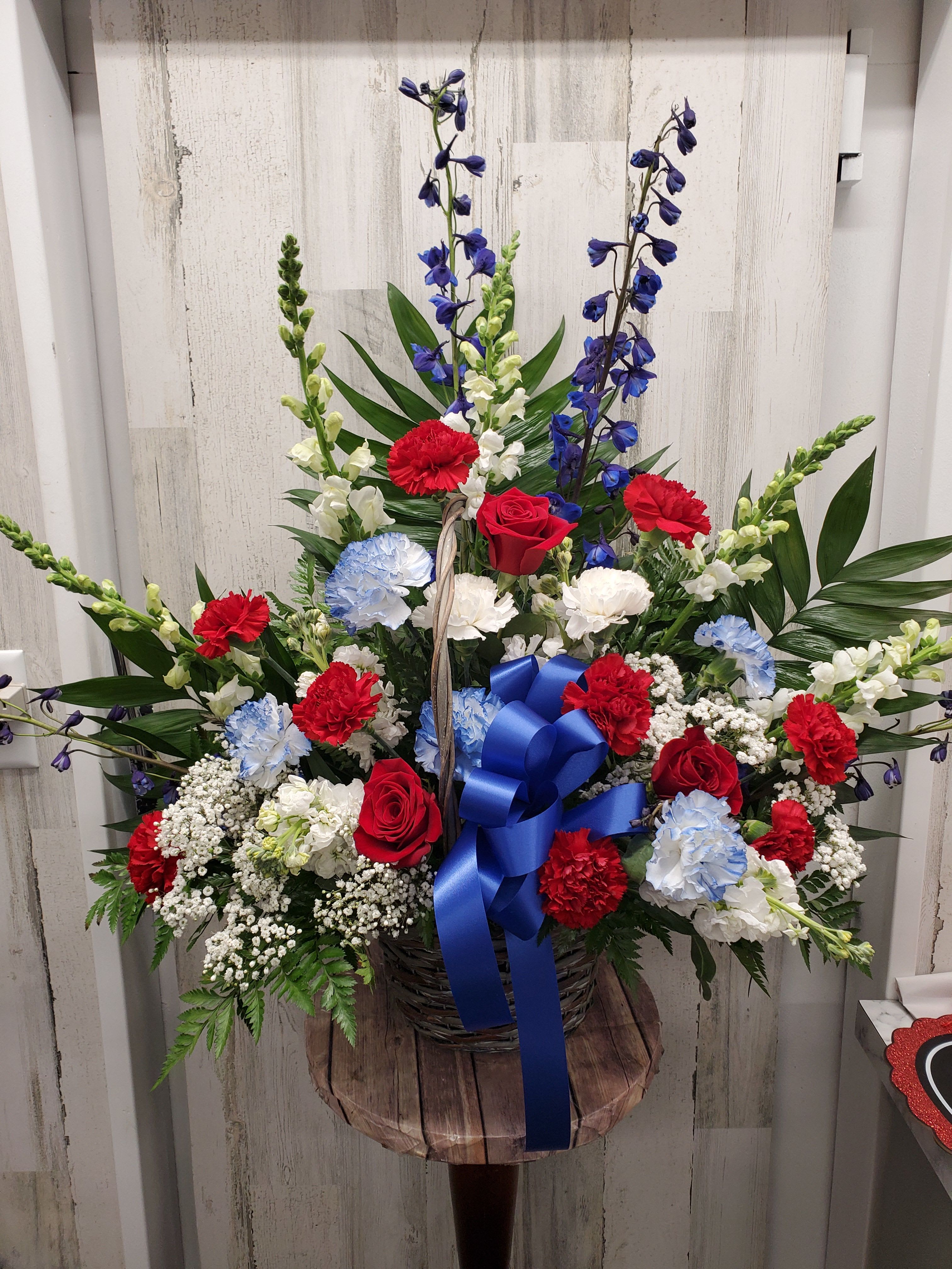 Grace  - This beautiful, tasteful arrangement of classic red and white flowers is a lovely expression of caring. It will be a comfort to the family, who will long remember your thoughtfulness during a time of loss. 
