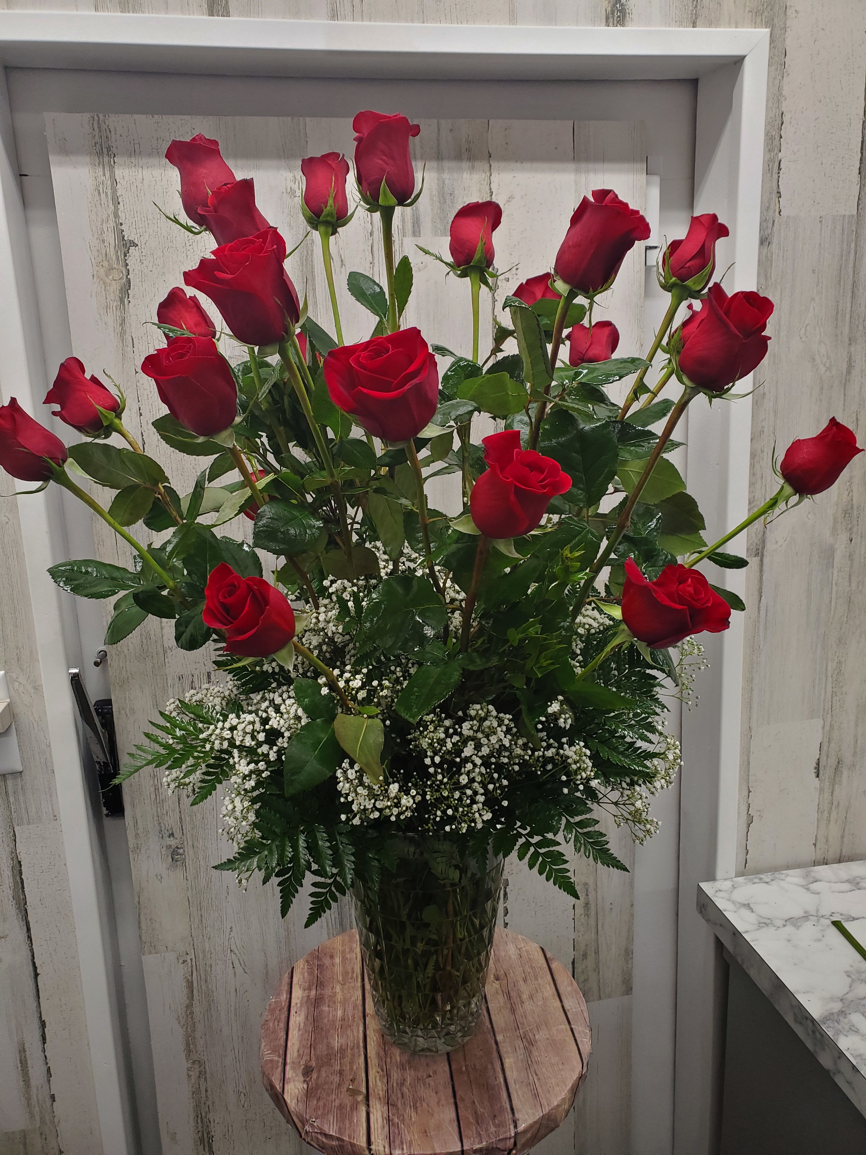 Gwyneth - When it comes to romance, the red rose rules! And when it comes to delivering romance in a big way, two dozen gorgeous red roses are a brilliant choice.  Twenty-four stunning red roses are arranged with greenery and delivered in a feminine vase.  