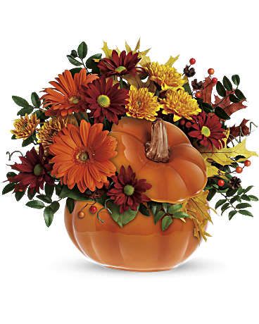 Telefloras Counrty Pumpkin - This pumpkin is sure to please! Send your special someone fall flowers and a keepsake gift with this reusable ceramic pumpkin arrangement. The fun Halloween decoration or spirited fall floral decoration for the home or office can later be used to serve Thanksgiving soup or stuffing! Orange gerberas, bronze cushion mums, red daisies, huckleberry and salal are accented with yellow oak leaves and artificial fall berries. Presented in a reusable ceramic pumpkin container. Orientation: One-Sided