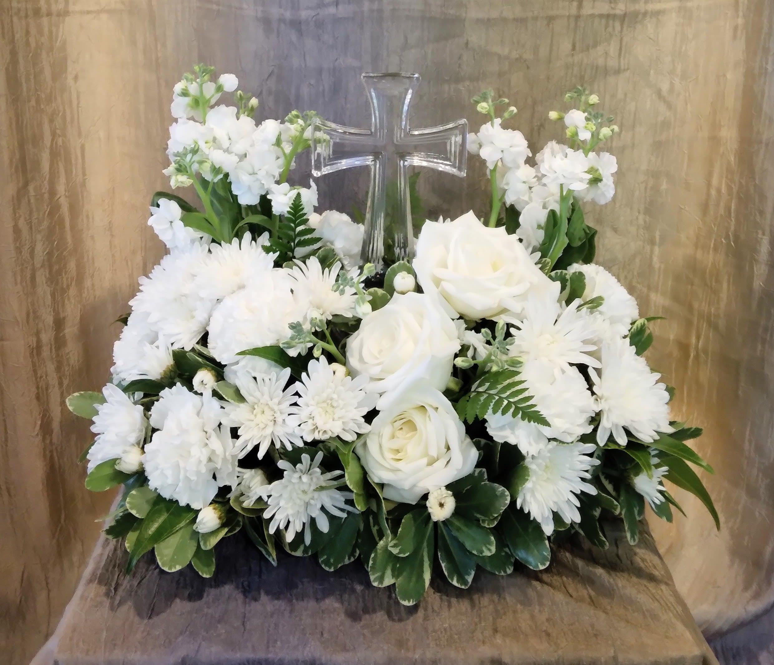 Cross Centerpiece ~ Flower A Day - SHOWN AT DELUXE -  A lovely clear glass cross is surrounded by a bed of beautiful white blossoms is sure to be appreciated.    