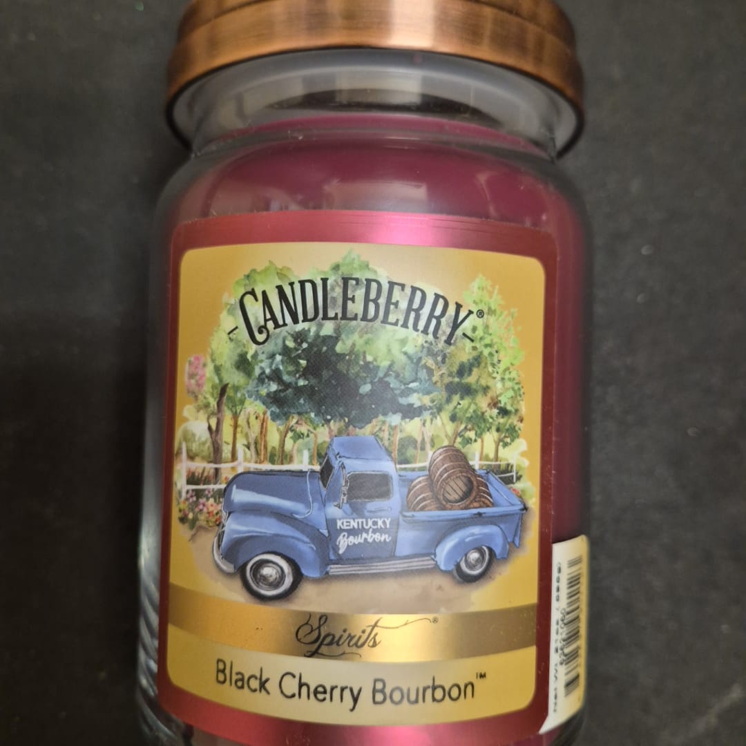 A jar candle labeled Candleberry Black Cherry Bourbon
