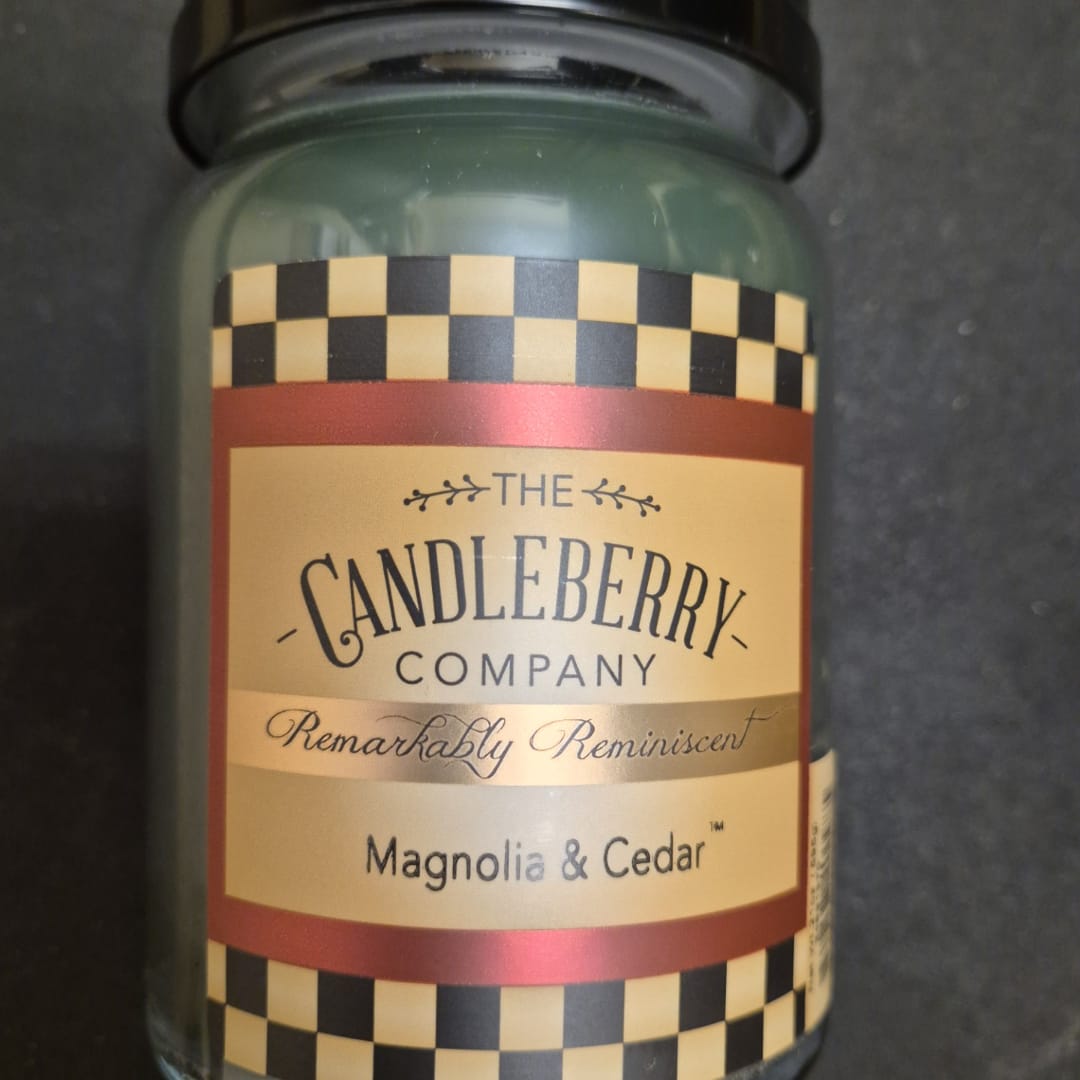 Glass candle jar labeled Magnolia &amp; Cedar