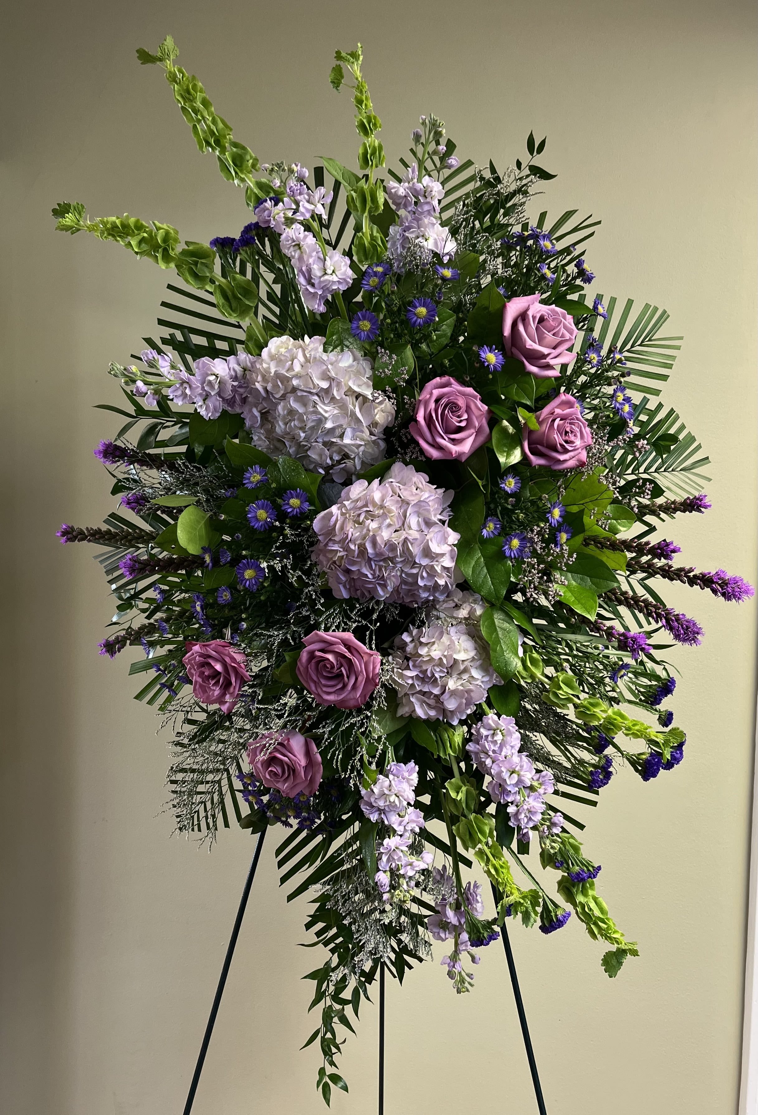 Tall standing floral spray with pink roses and lavender blooms
