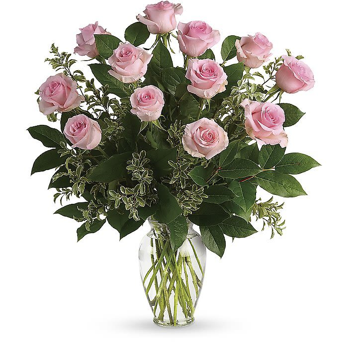 Pink roses arranged in a clear glass vase