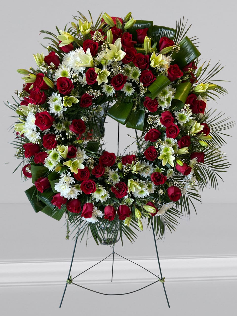 Lasting Serenity - A beautiful white, red and green tribute wreath that calms, this easel arrangement celebrates a full life and a peaceful passing. 
