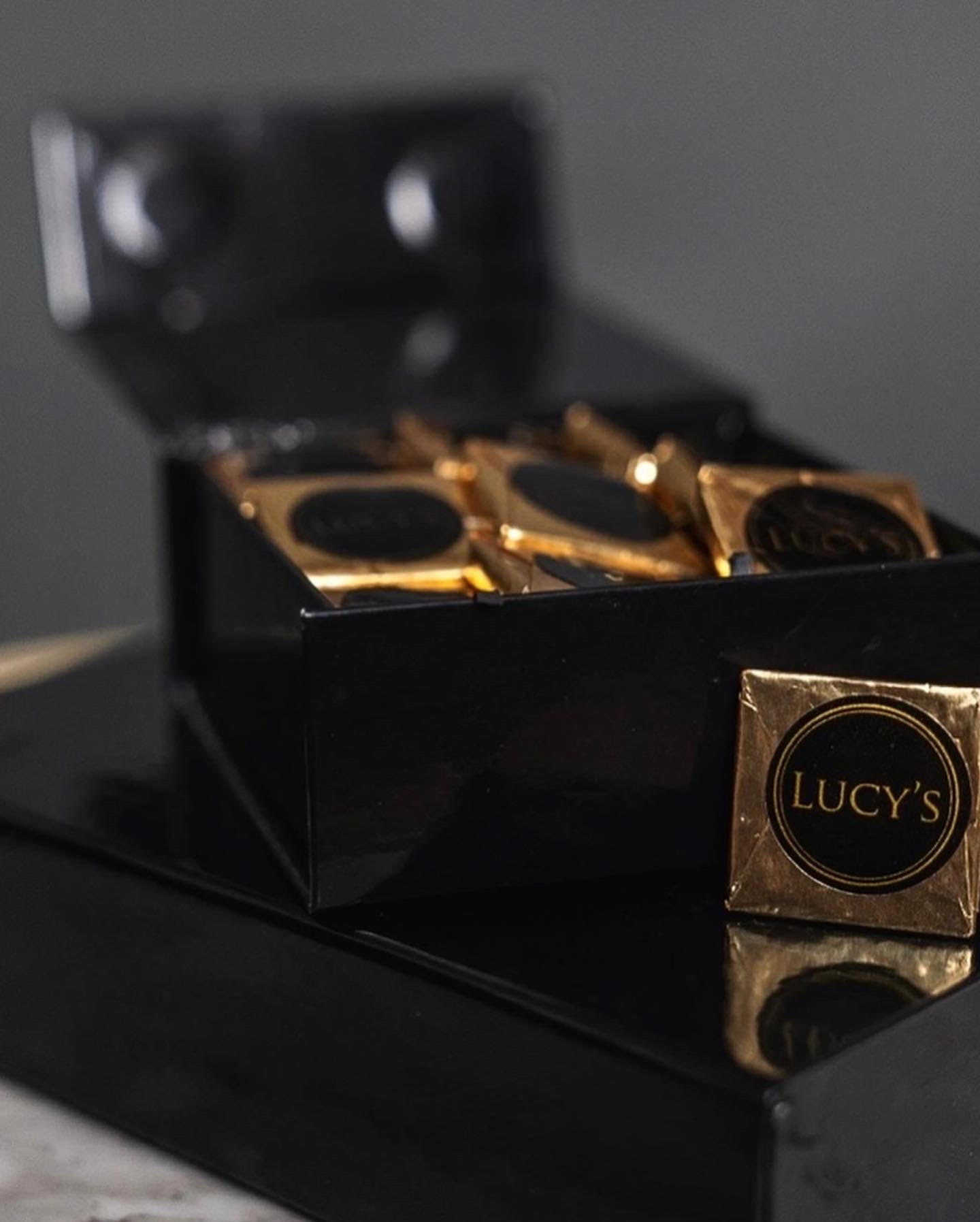 Box of gold-wrapped chocolates with Lucy's labels