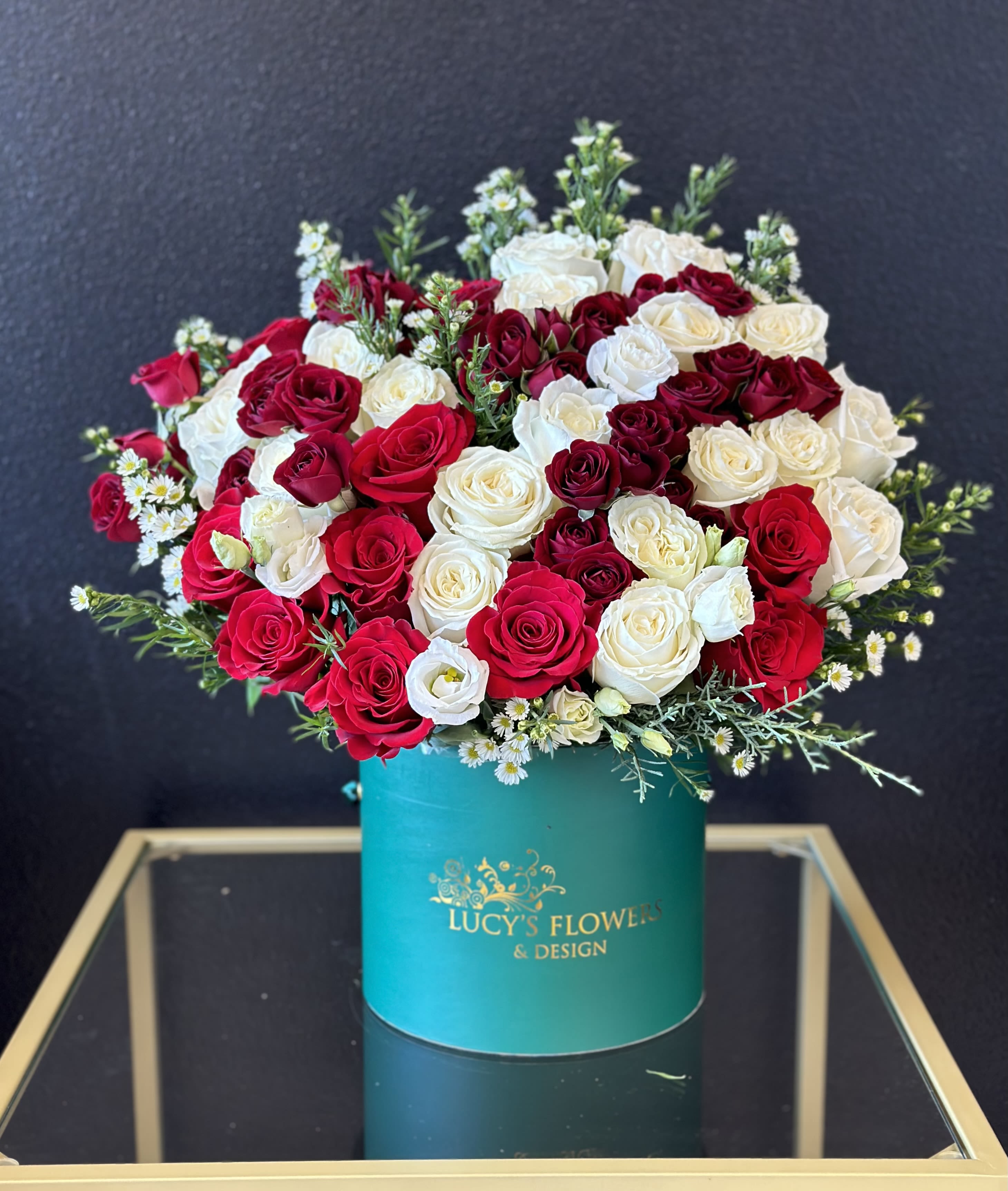 Holiday Secrets By Lucy’s Flowers - We all have secrets… It’s time to celebrate these feelings with Holiday Secrets. Show someone that you care with this arrangement, even if that’s no secret at all. Surprise them with this unique arrangement this holiday season.  Arrangement Includes: -Fresh Cut Roses  -Lucy’s Small Signature Box -Custom Greeting Card -Care Instructions