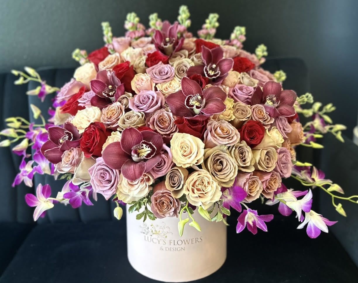 Amethyst Magic - Amethysts can come in a variety of beautiful purple colors just like this arrangement. Featuring the most unique flowers, such as orchids, amnesia  roses, tulips, and stocks this arrangement makes a beautiful February birthday present, a lovely congratulations gift and even a perfect way to say "I Love You" tp your Valentine...  Arrangement Includes: -Fresh Cut Roses -Cymbidium Orchids -Lucy's Signature Medium Size Box -Custom Greeting Card 