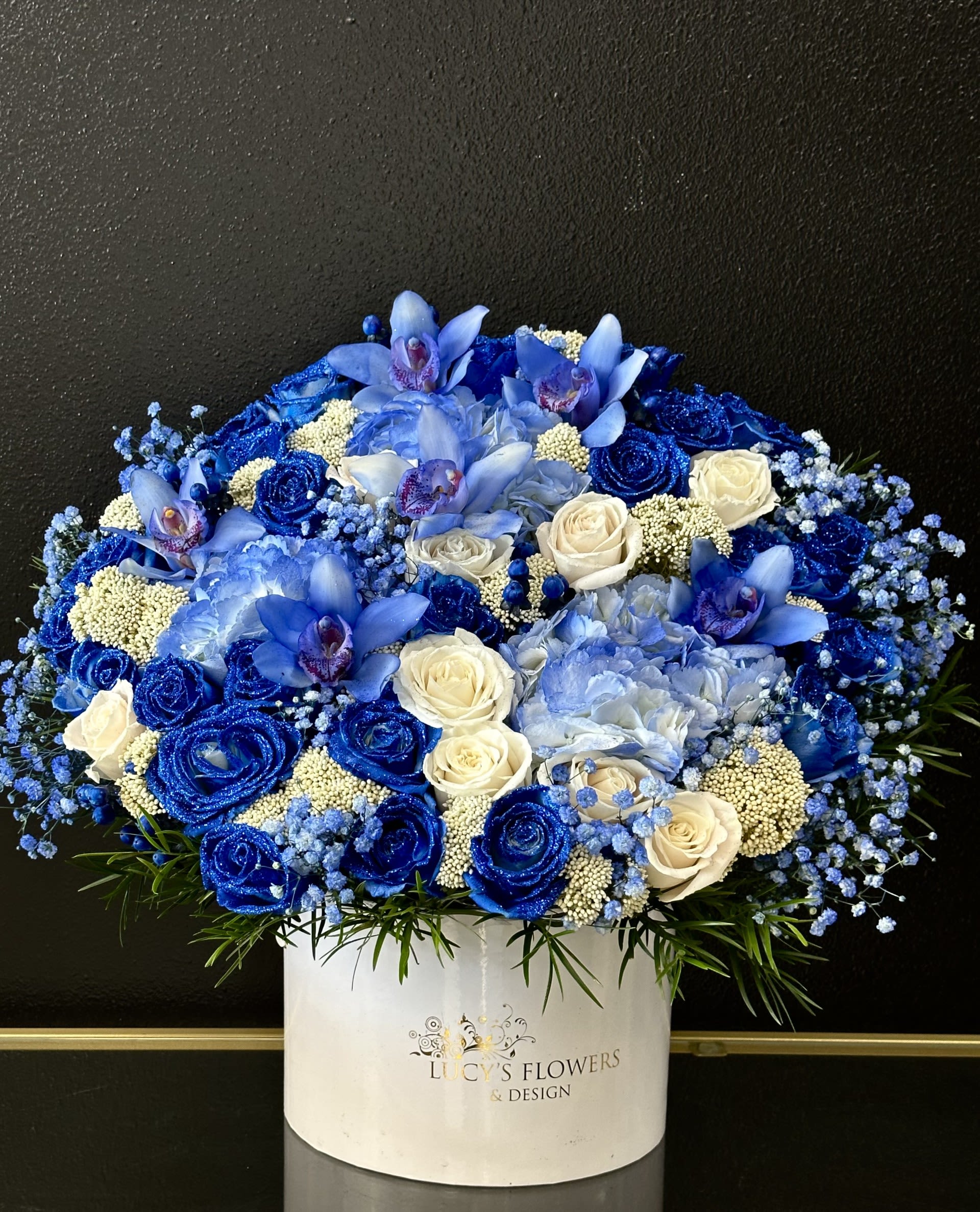 Blue and white floral arrangement in a white box