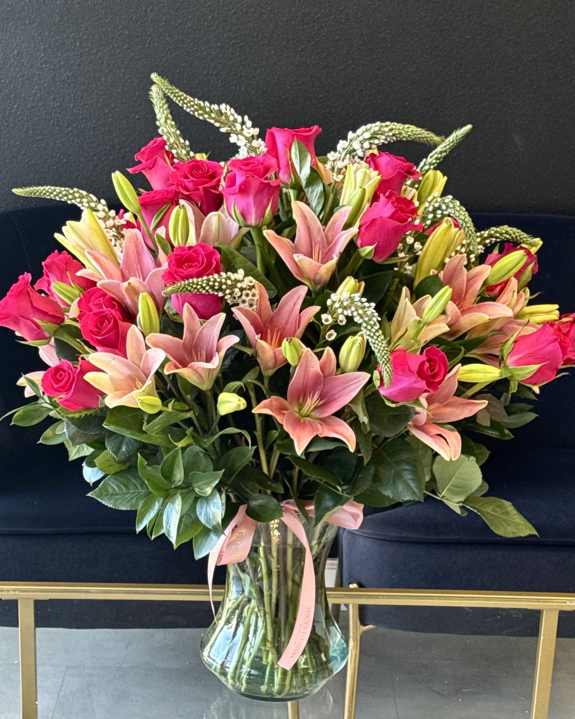 Lily Rose Bloom - A soft and elegant vase arrangement featuring fresh lilies and roses in complimentary shades of pink, thoughtfully arranged to bring warmth and beauty into any space.  Arrangement Includes: -Fresh Cut Roses, Lilies &amp; Other Blooms -Glass Vase -Custom Greeting Card -Care Instructions