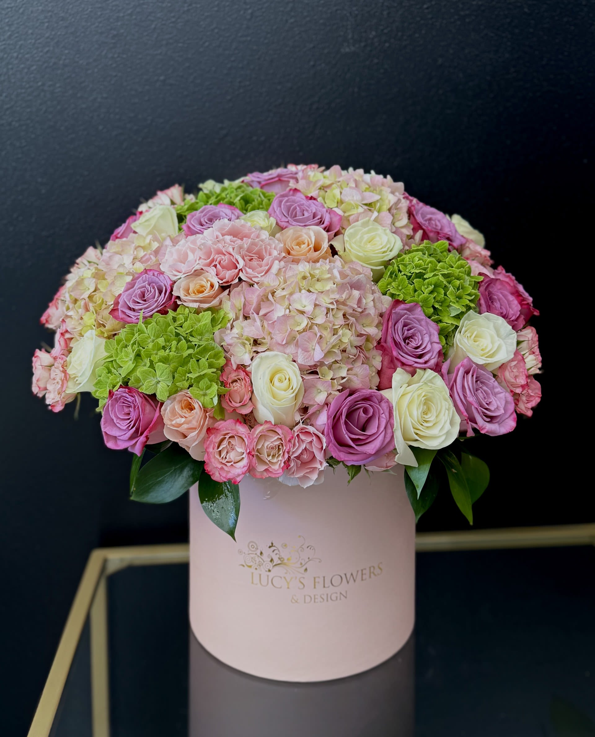 Petals For Her - A soft and luxurious floral arrangement designed in a romantic pastel tones with premium roses, hydrangeas and seasonal blooms, Perfect for Mother's Day, birthdays, baby celebrations, congratulations or simply making someone feel special.  Arrangement Includes: -Fresh Cut Roses, Hydrangea, and other Blooms -Lucy's Signature Medium Box -Custom Greeting Card -Care Instructions 