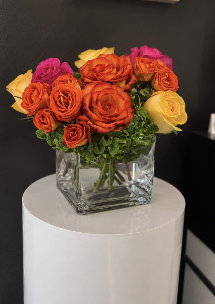 Bright Morning! - Pink, yellow and orange roses come together with green hydrangea for a bright cube of sunshine. This arrangement lights up any space and will improve anybody's day. A perfect gift for all occasions.   APPROXIMATE DIMENSIONS 10" W X 11" H 