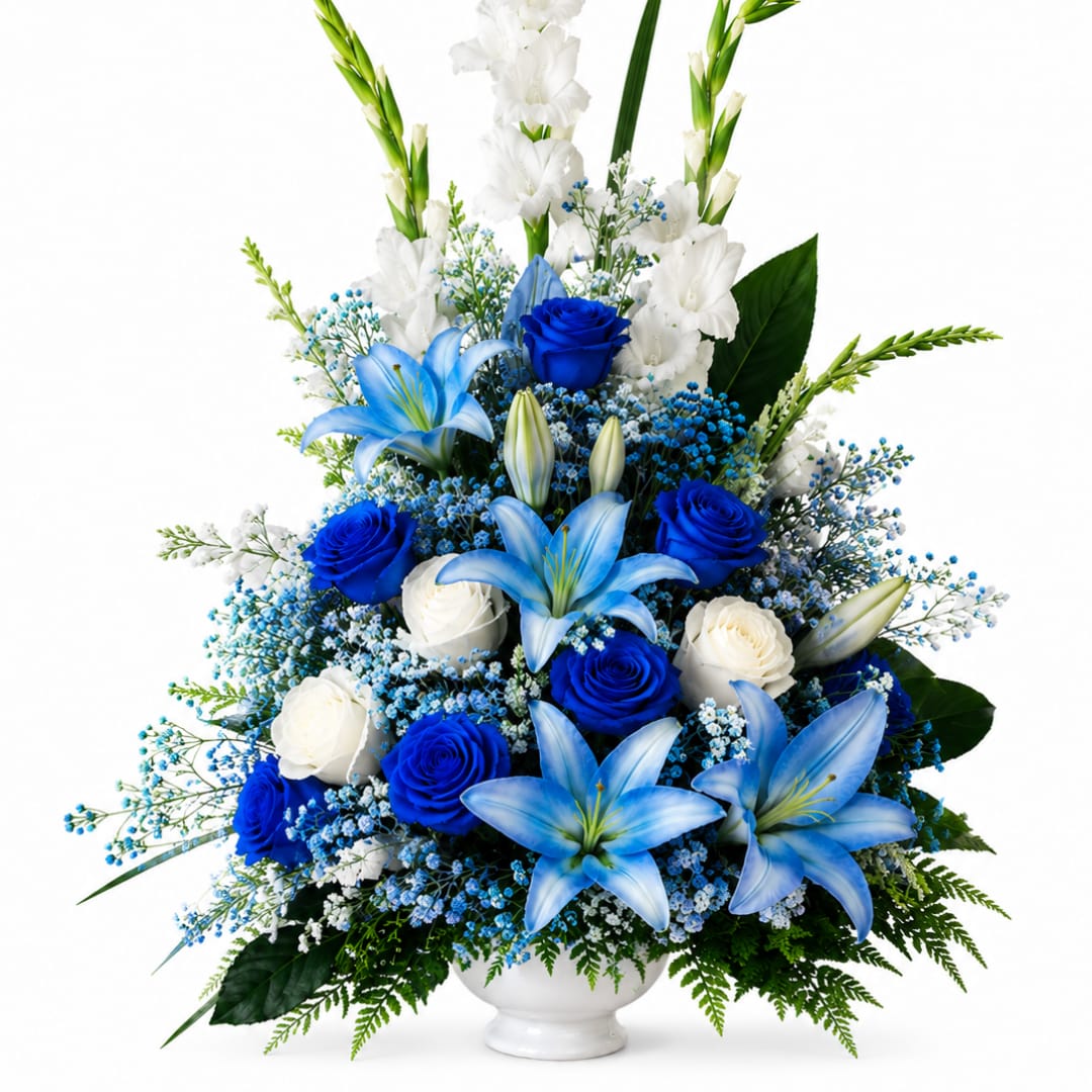 Blue and white floral arrangement in a white vase with lilies and roses
