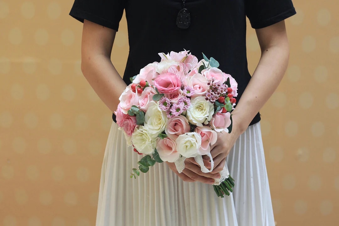 love - include pink roses, white roses, daisies, red berries, eucalyptus leaves ,Tied together with a specific ribbon 