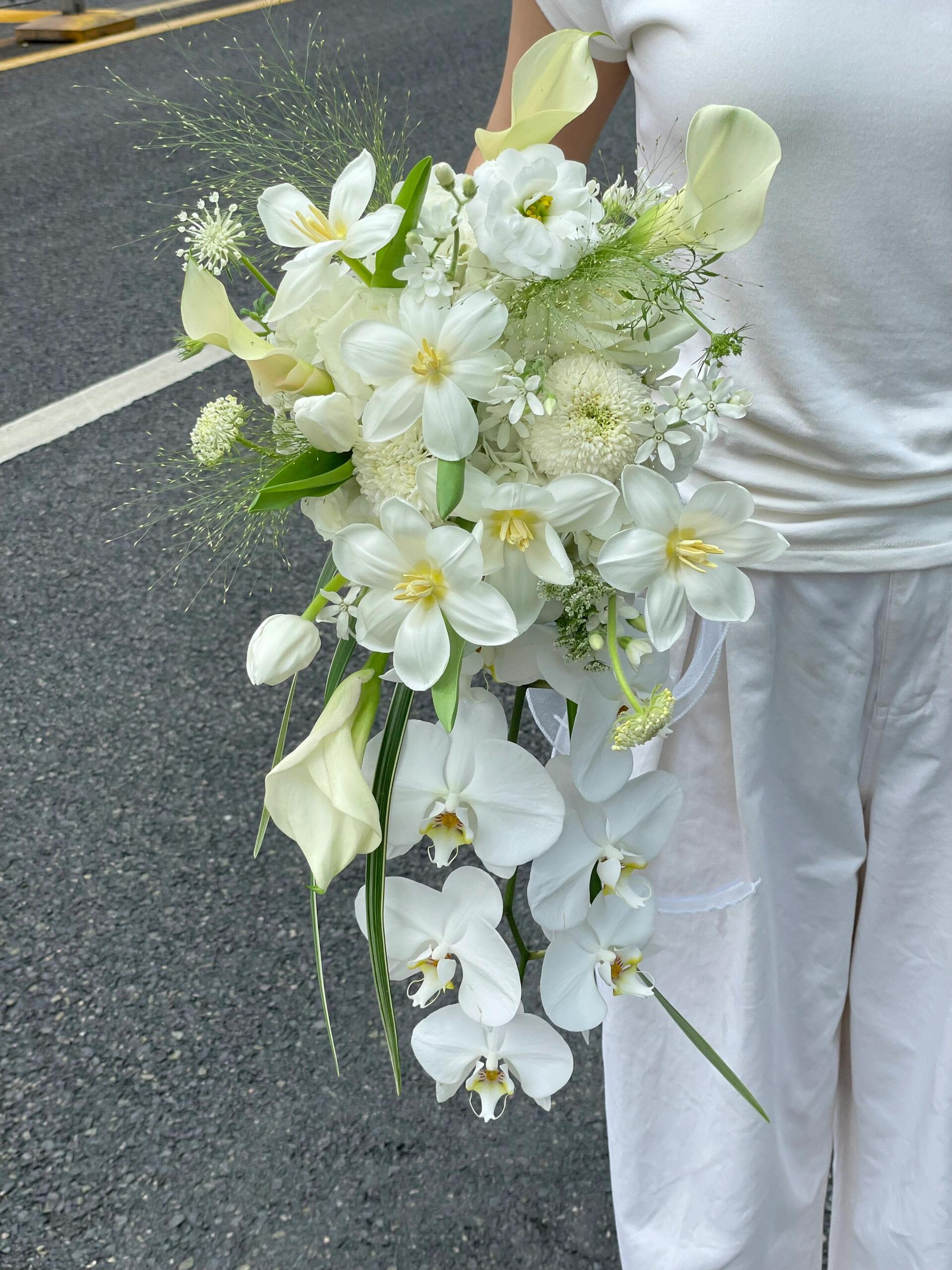 White bridal bouquet with orchids, calla lilies, and tulips
