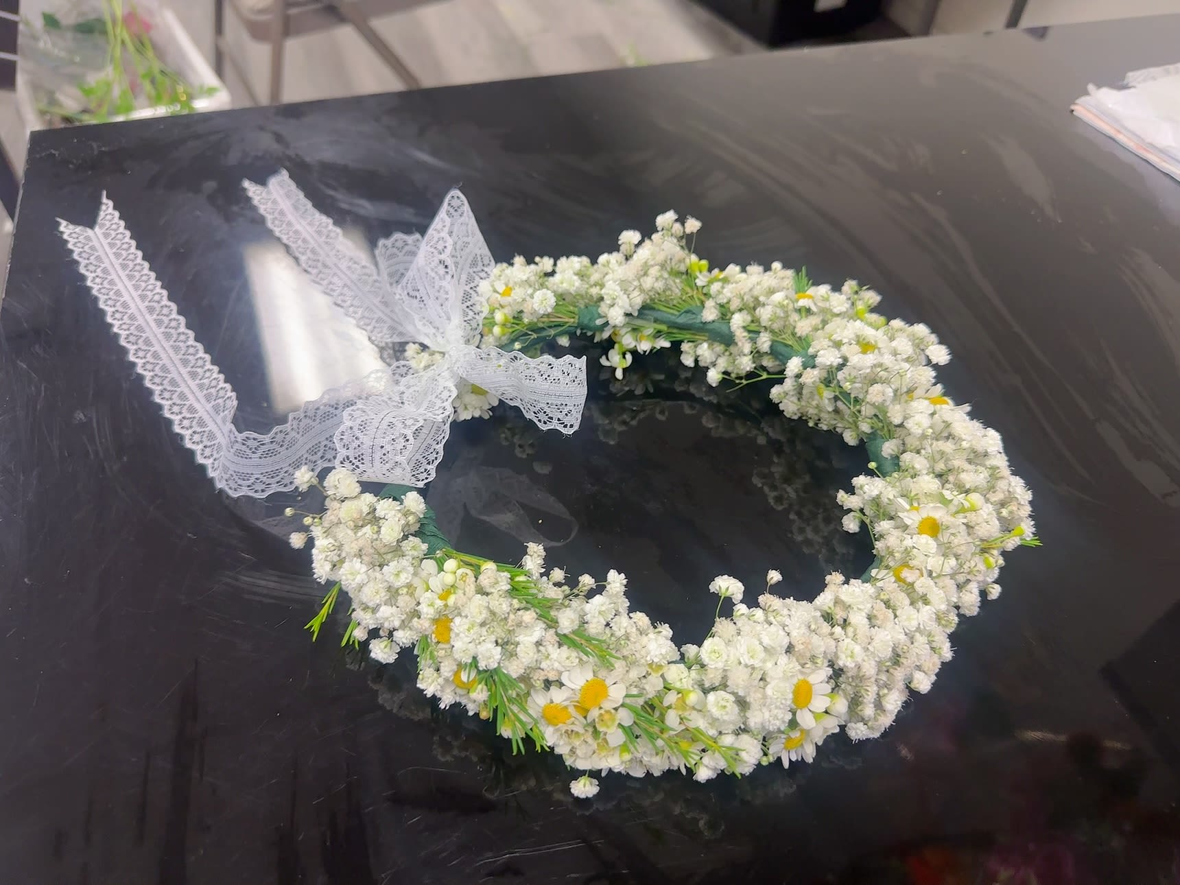 White floral crown with small daisies and lace ribbon