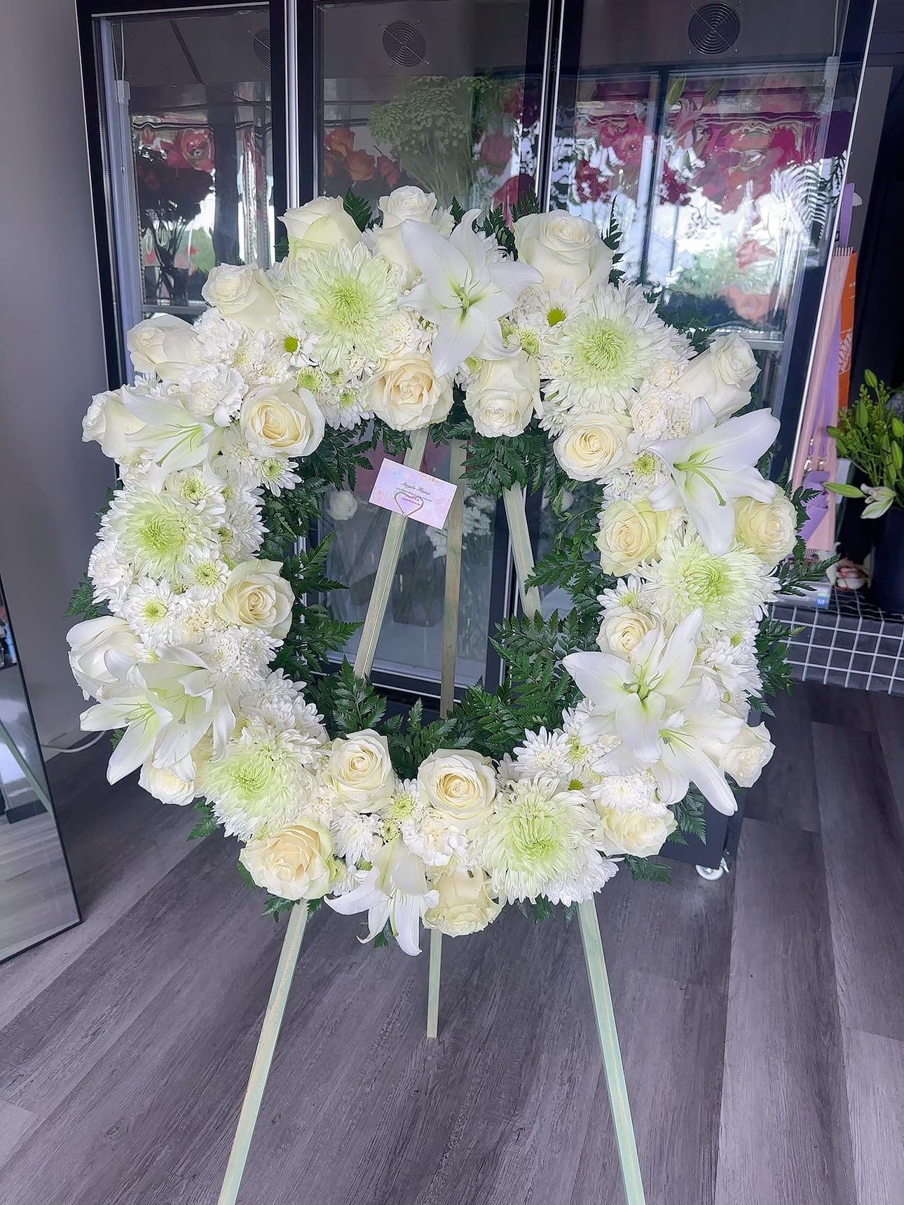 White floral wreath on a standing easel