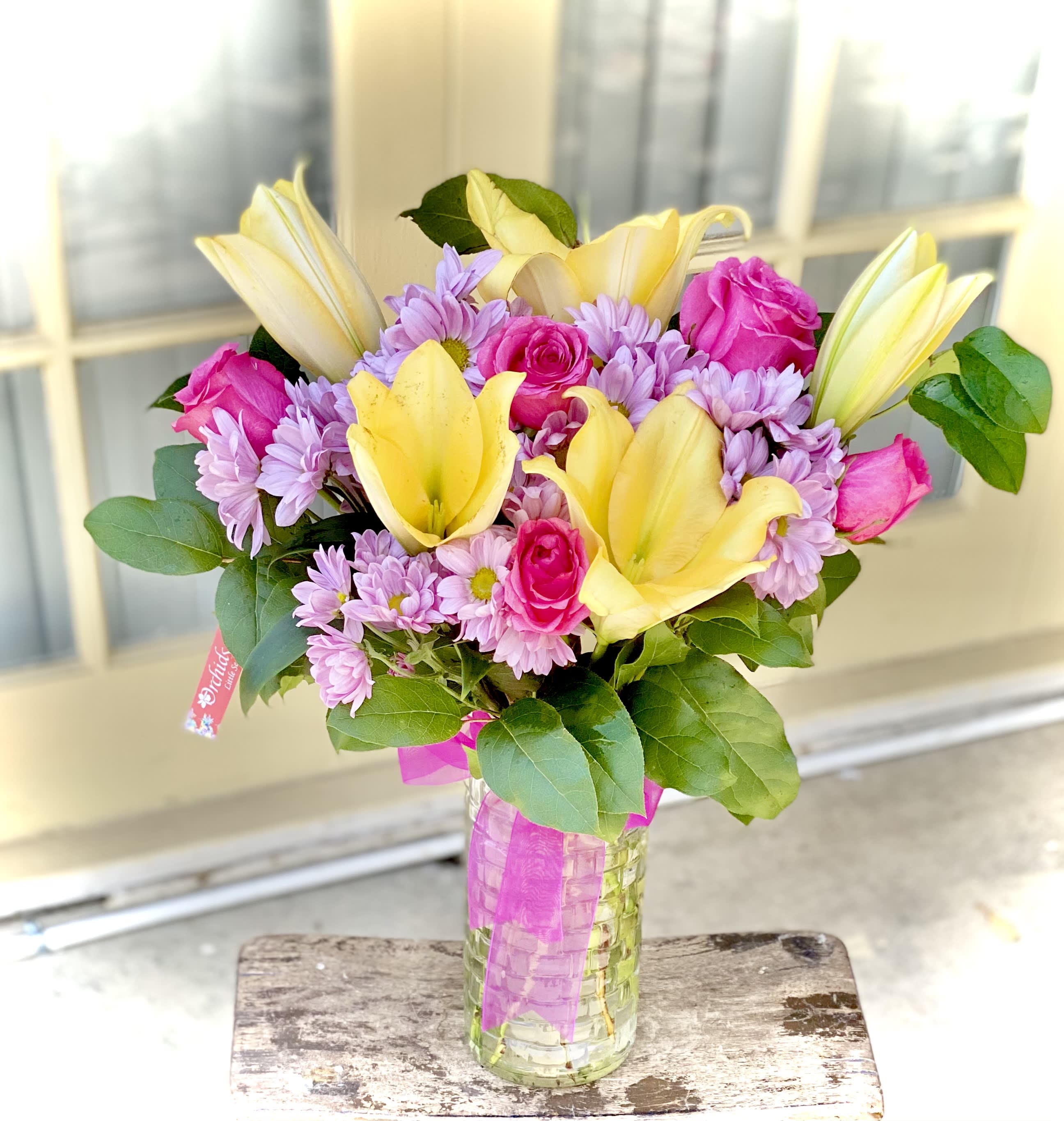 Yellow Lily &amp; Pink Rose Spring Bouquet  - Celebrate any occasion with our vibrant yellow lilies, hot pink roses accented with other blooms bouquet arranged in a clear gathering vase.  
