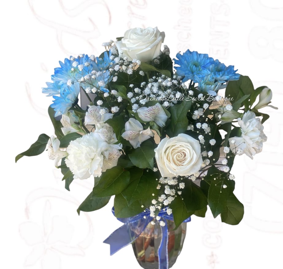 White and blue flower bouquet in a glass vase with ribbon