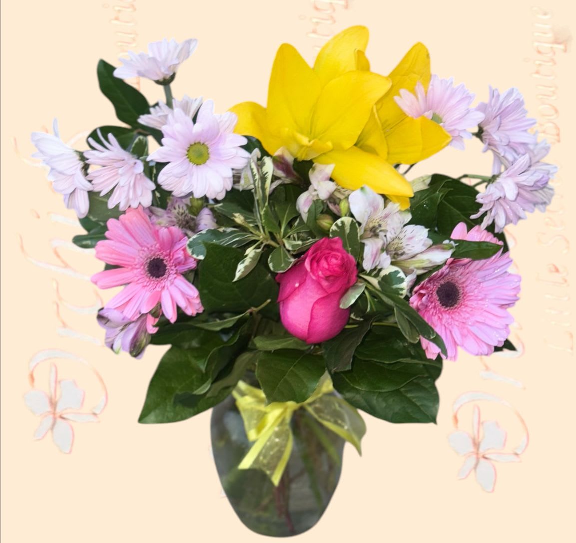 Bouquet of pink and lavender daisies with a yellow lily in a vase