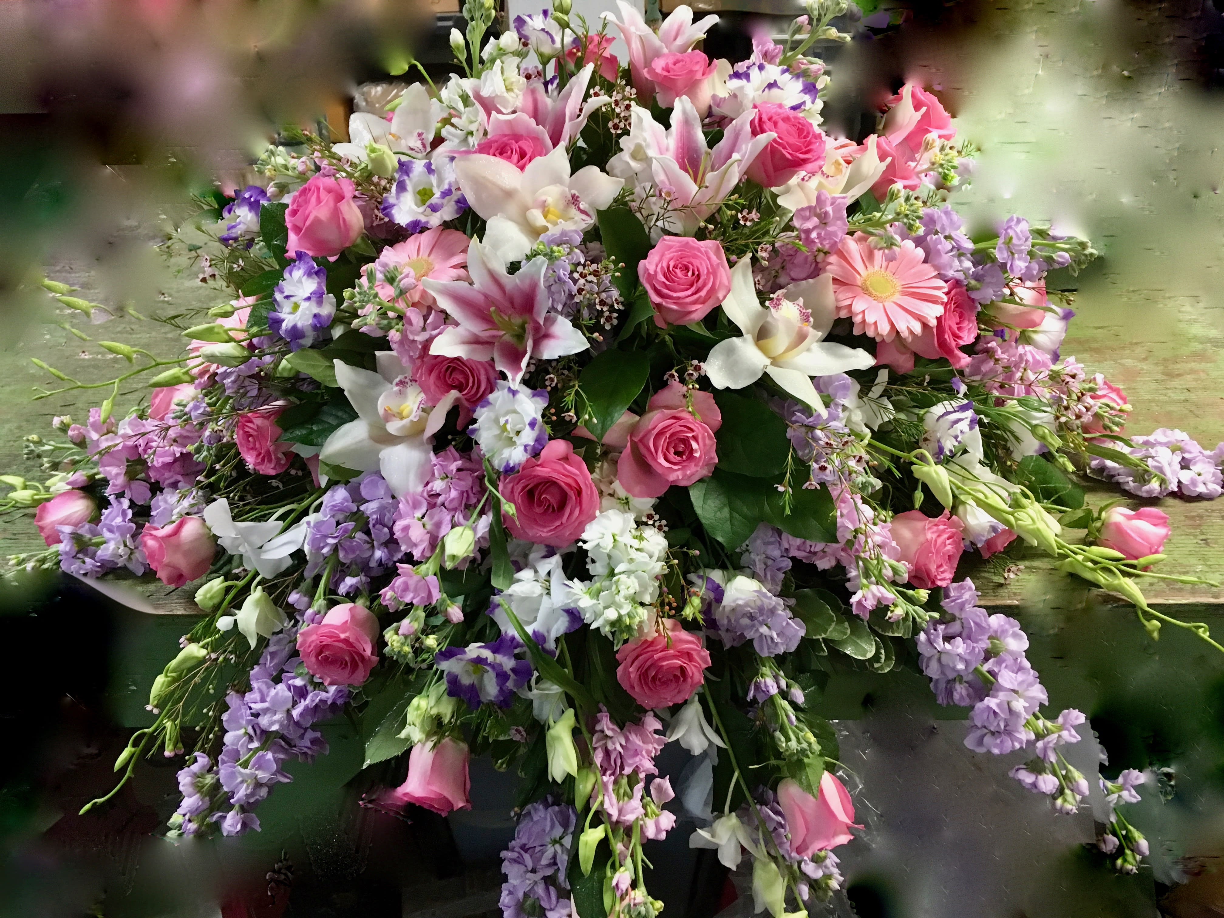 Large bouquet of pink roses, lilies, and purple flowers