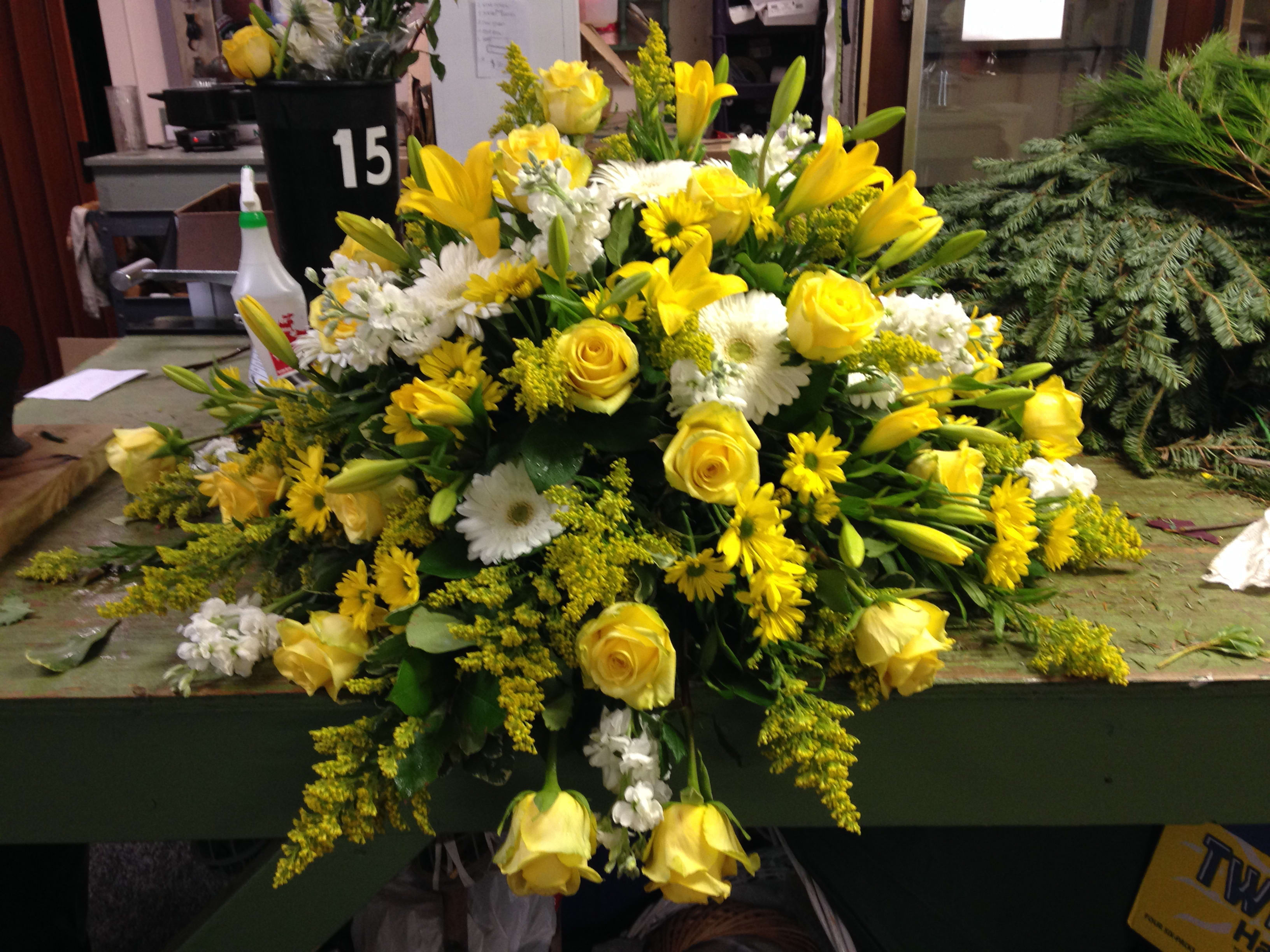 Yellow and white floral arrangement with roses and lilies
