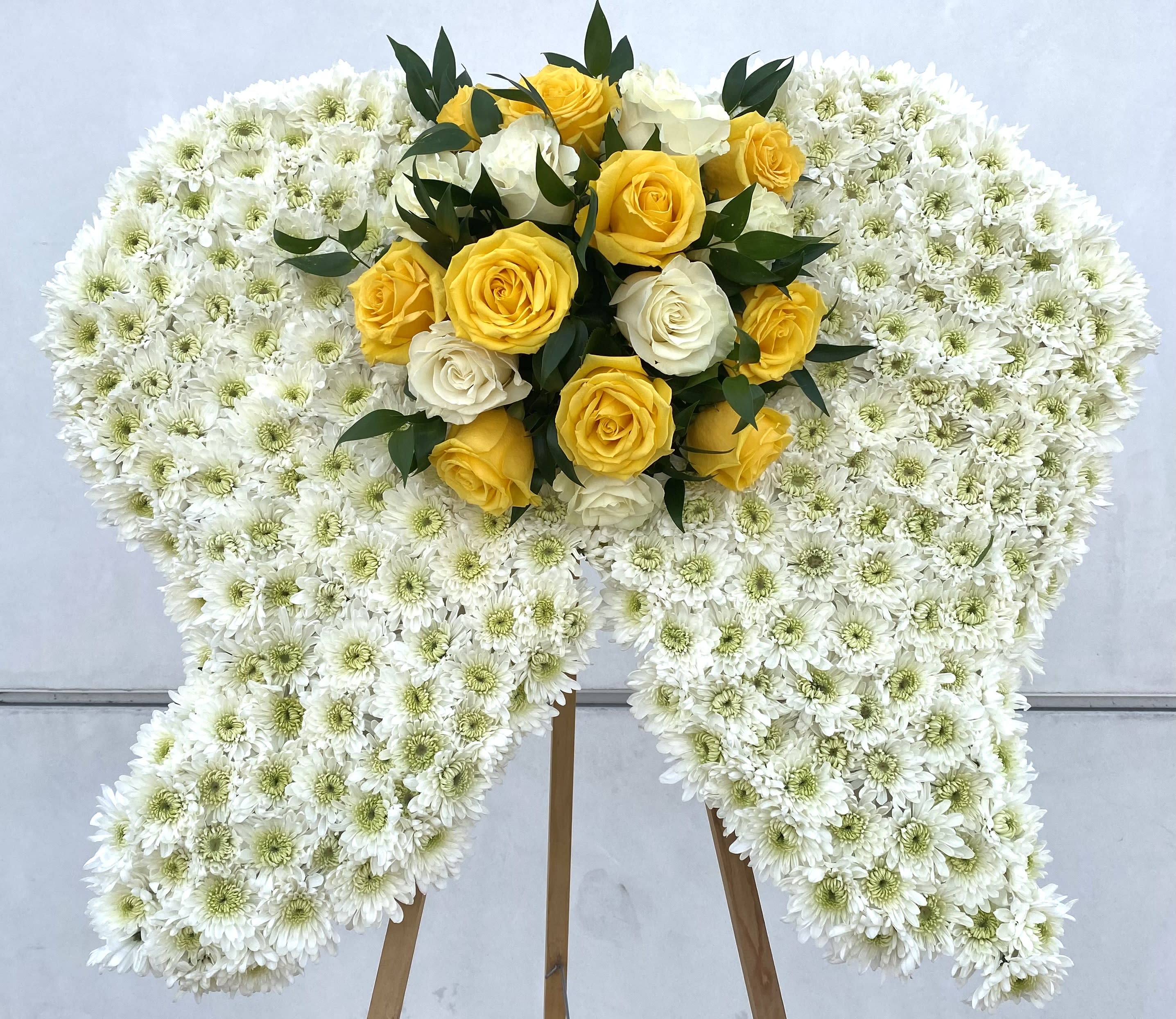 White chrysanthemum standing spray with yellow and white roses