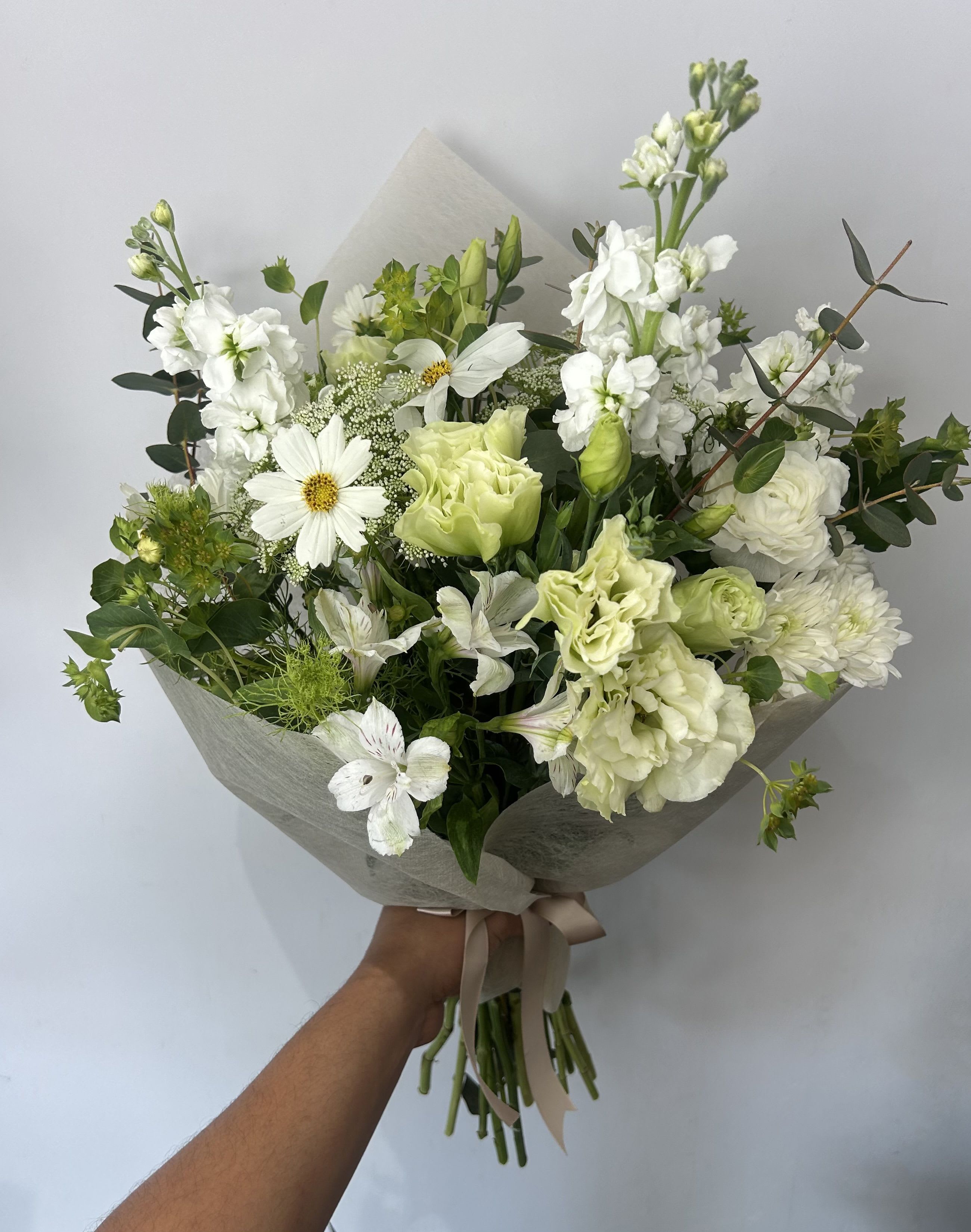 Wild Pearl - Seasonal wild white flowers arranged into a hand-tied bouquet with filler and greens. 