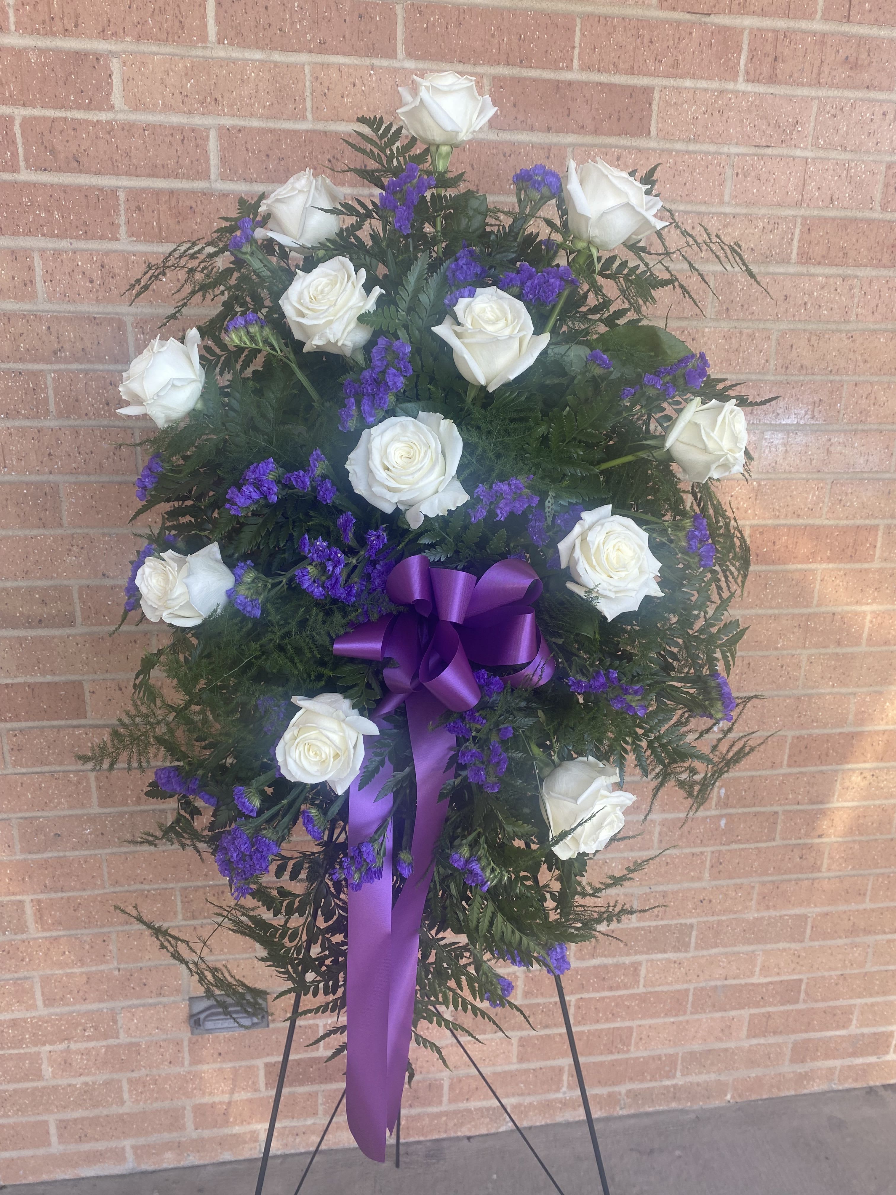 White Rose Easel - One Dozen White Roses with Purple statice filler and greenery on an free standing easel