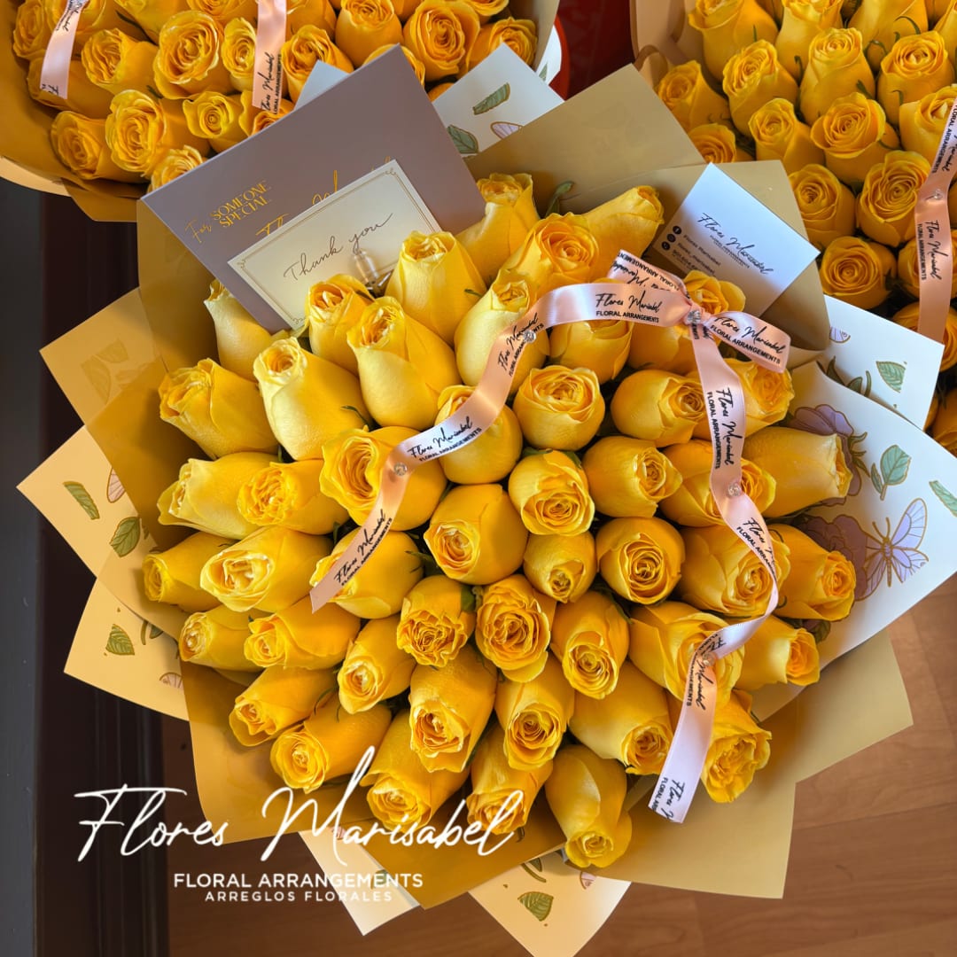 Bouquets of yellow roses wrapped in decorative paper with ribbon
