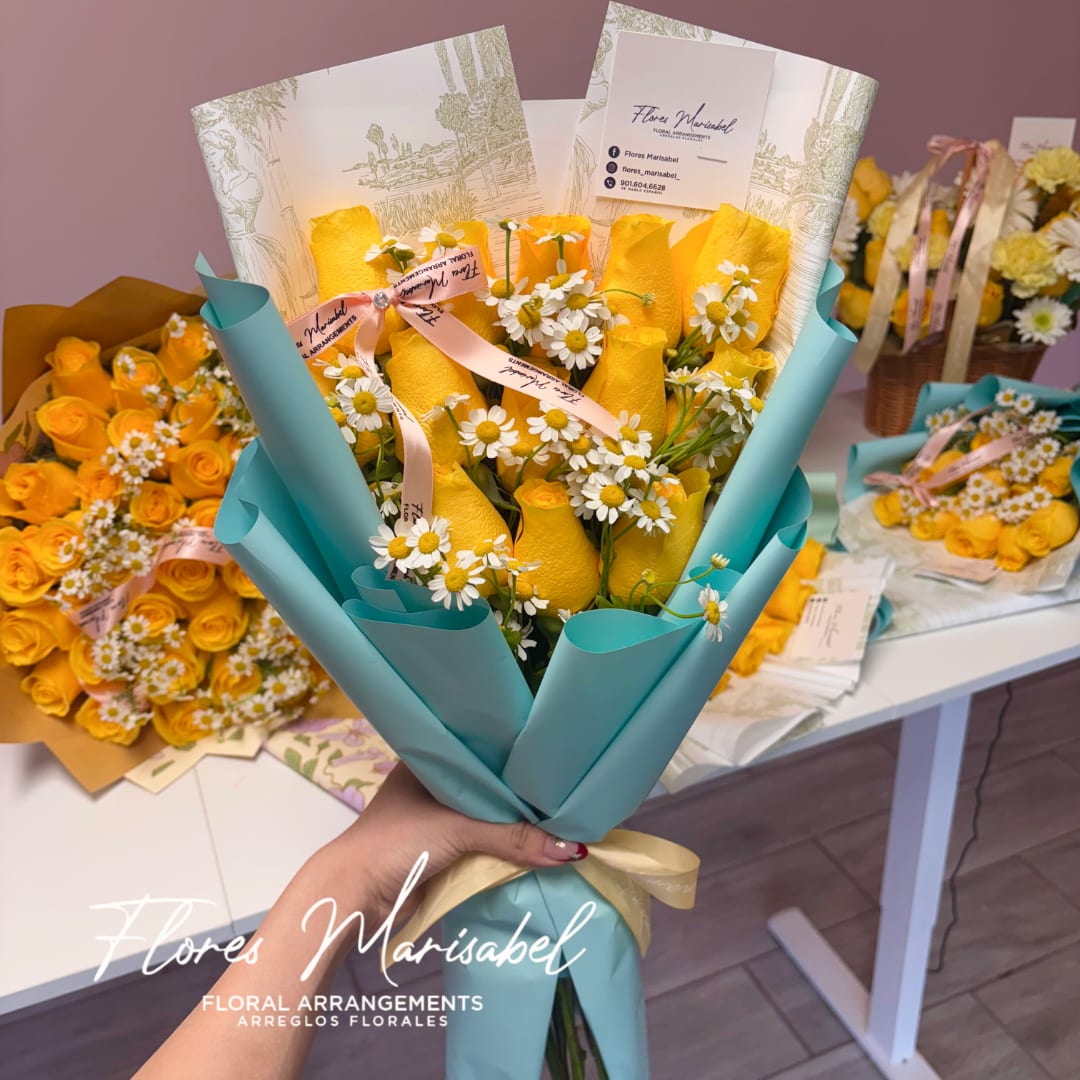 Yellow rose bouquet with white daisies wrapped in teal paper and ribbon